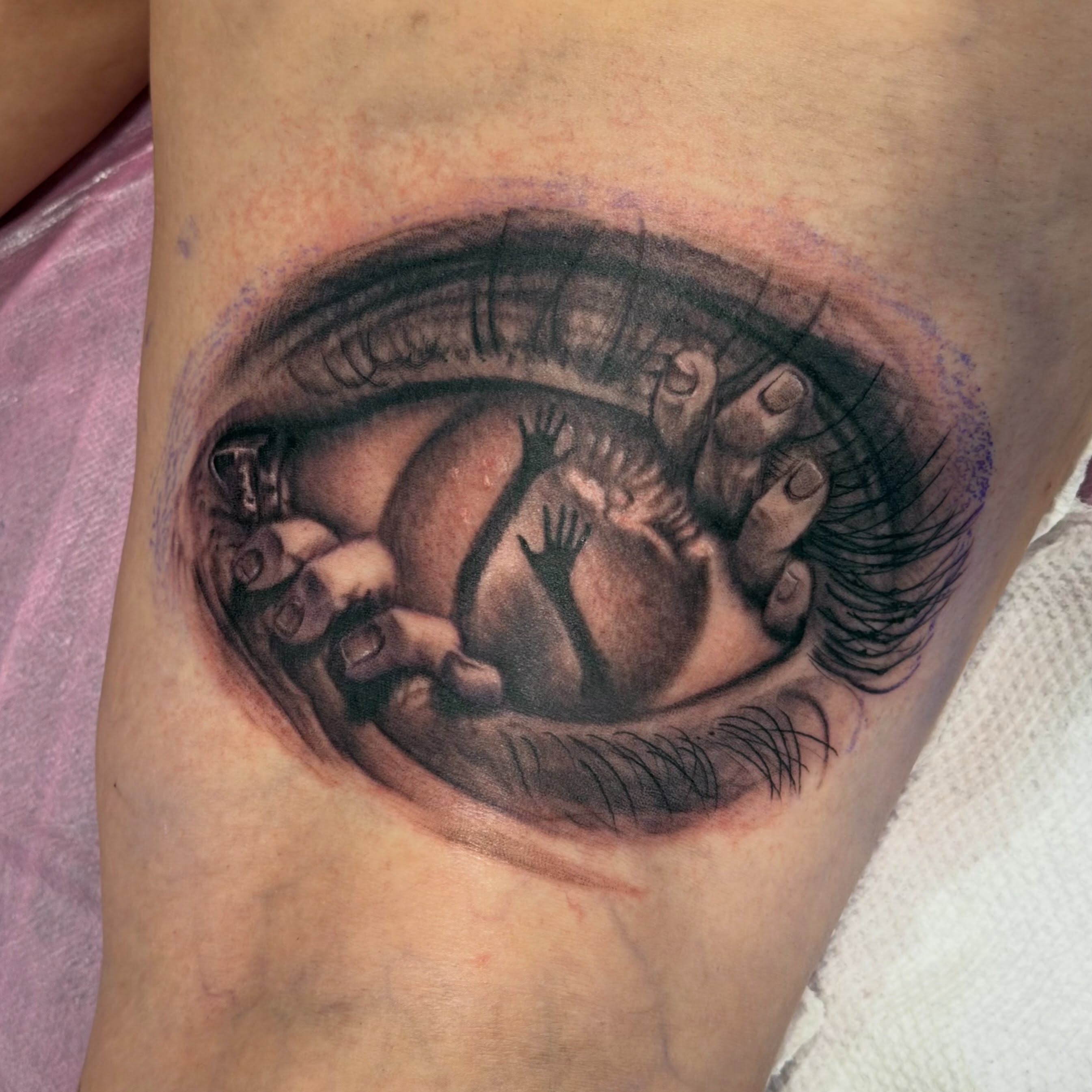 Eye with fetus realism tattoo on the thigh by Matthew Gordon