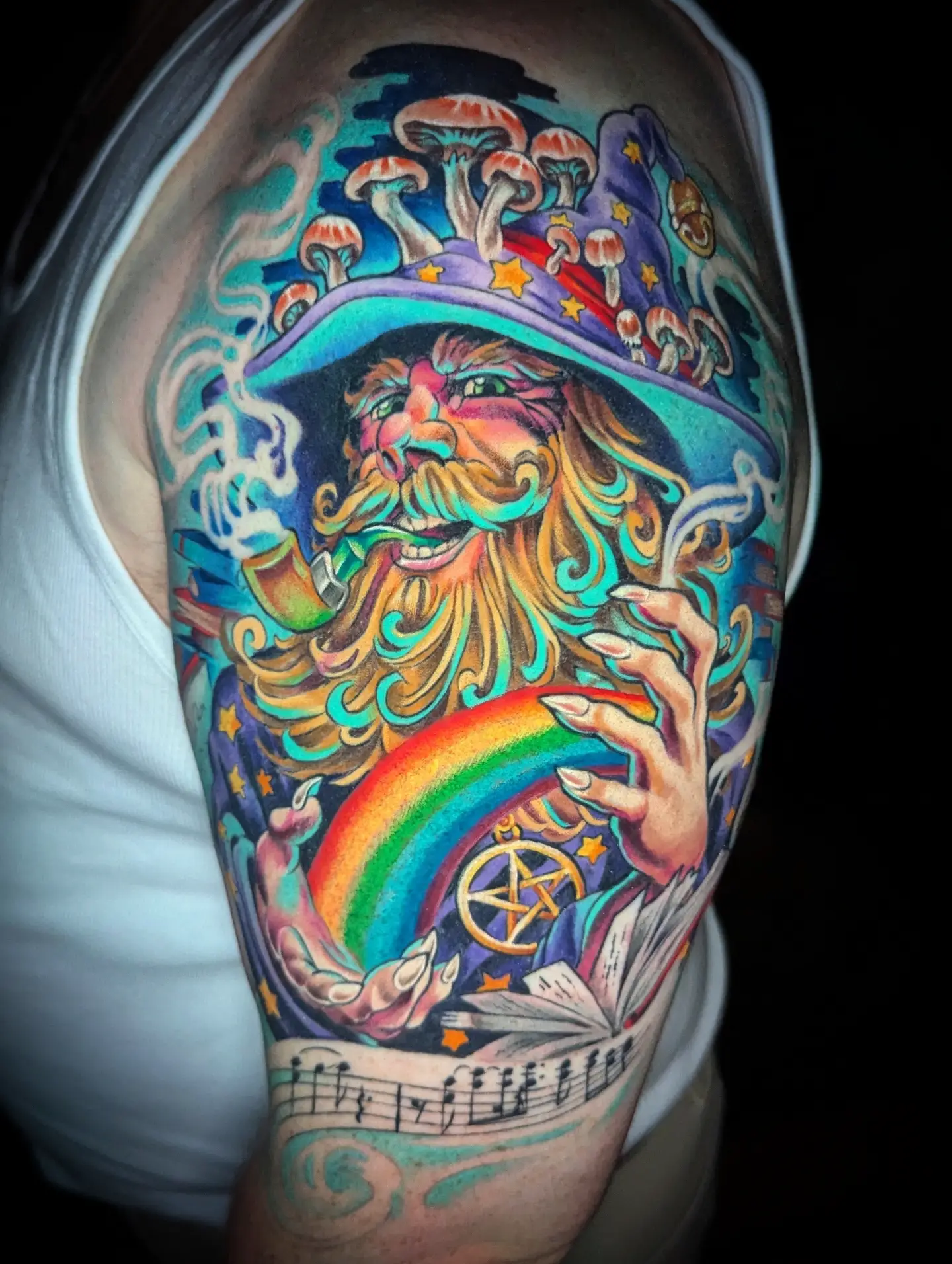 Wizard with rainbow new school tattoo on the shoulder by Devon Greig