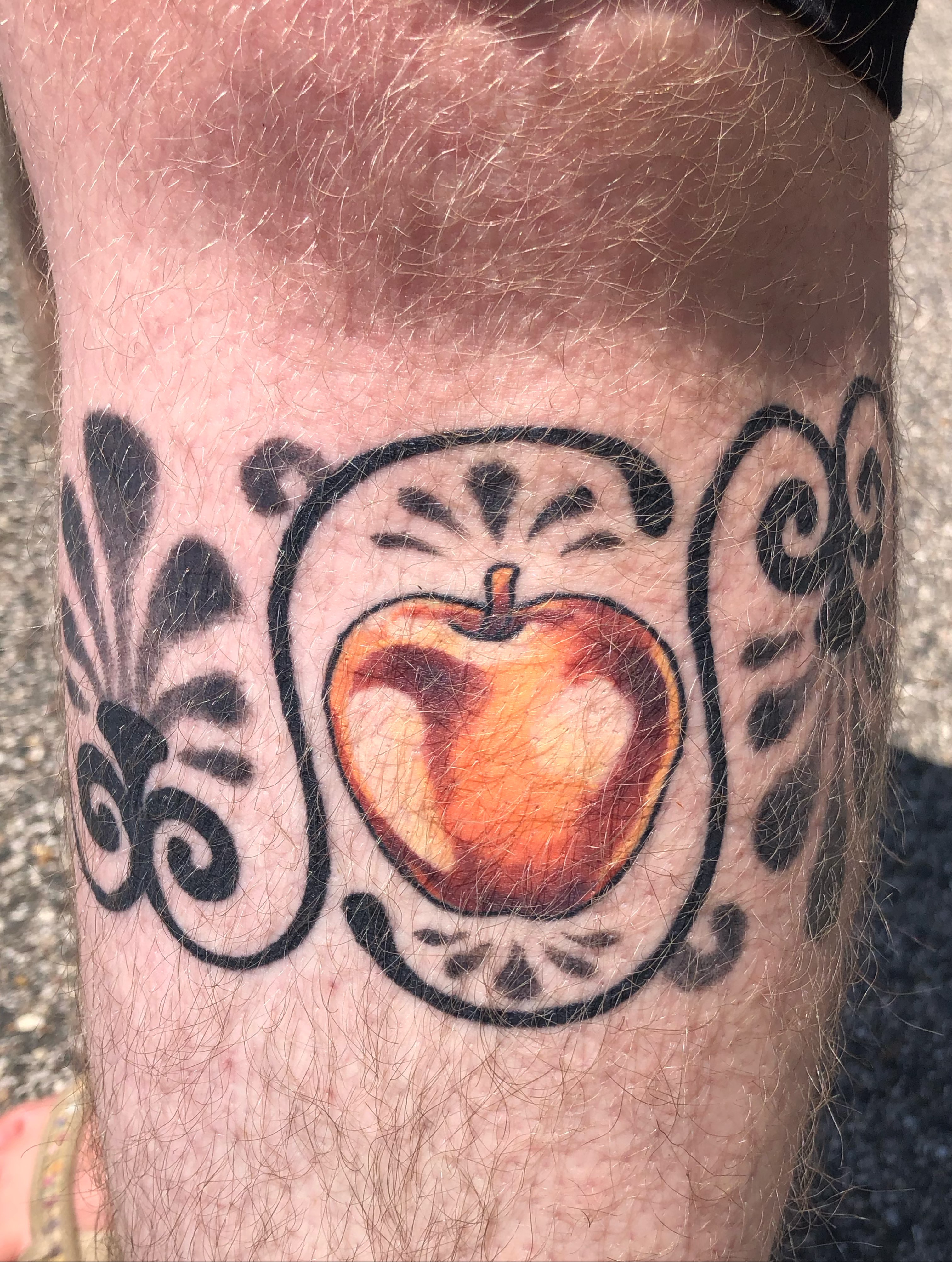 Apple American traditional tattoo on the forearm by Rowan Lee
