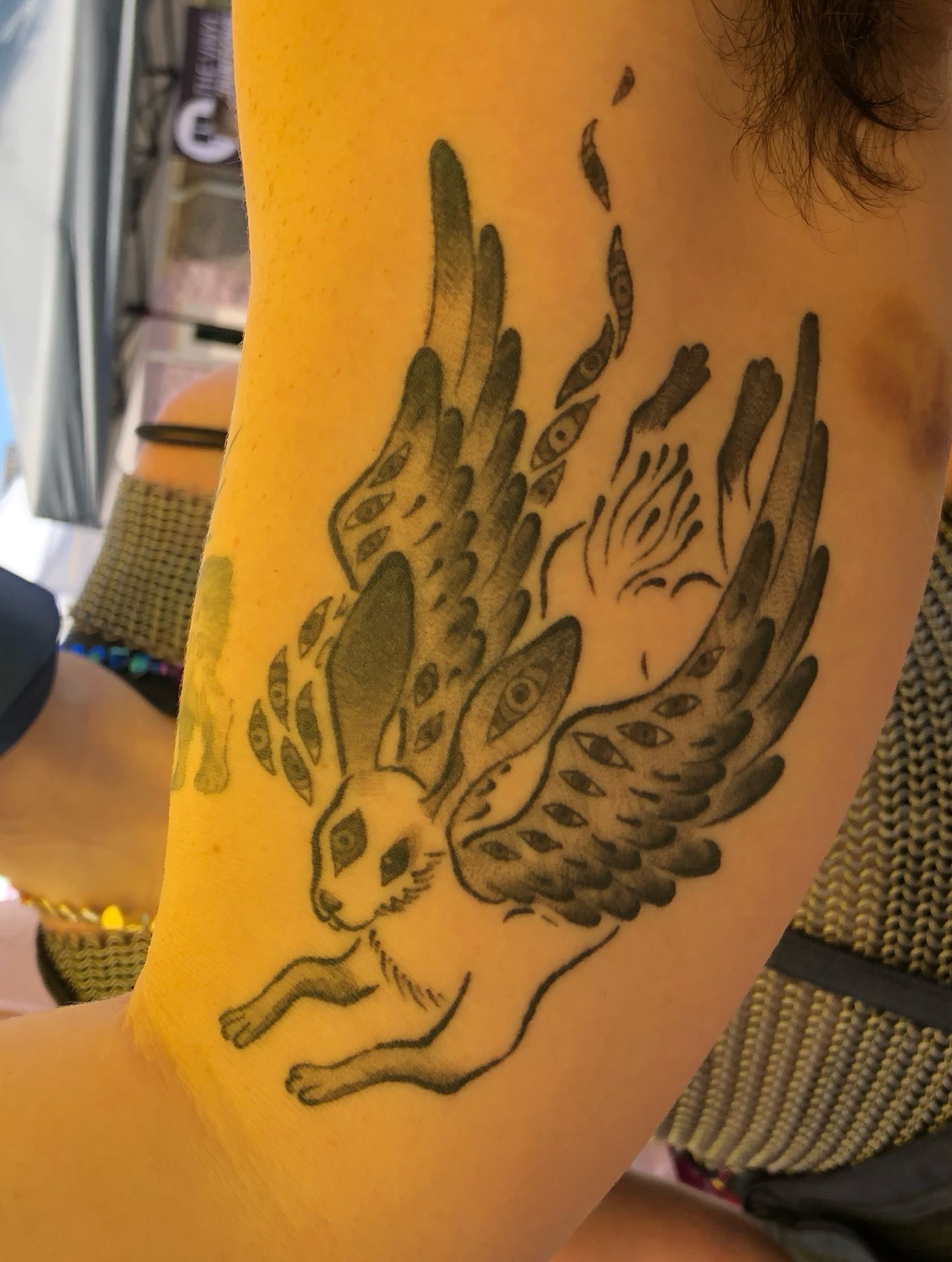 Winged rabbit black and grey tattoo on the forearm by Rowan Lee