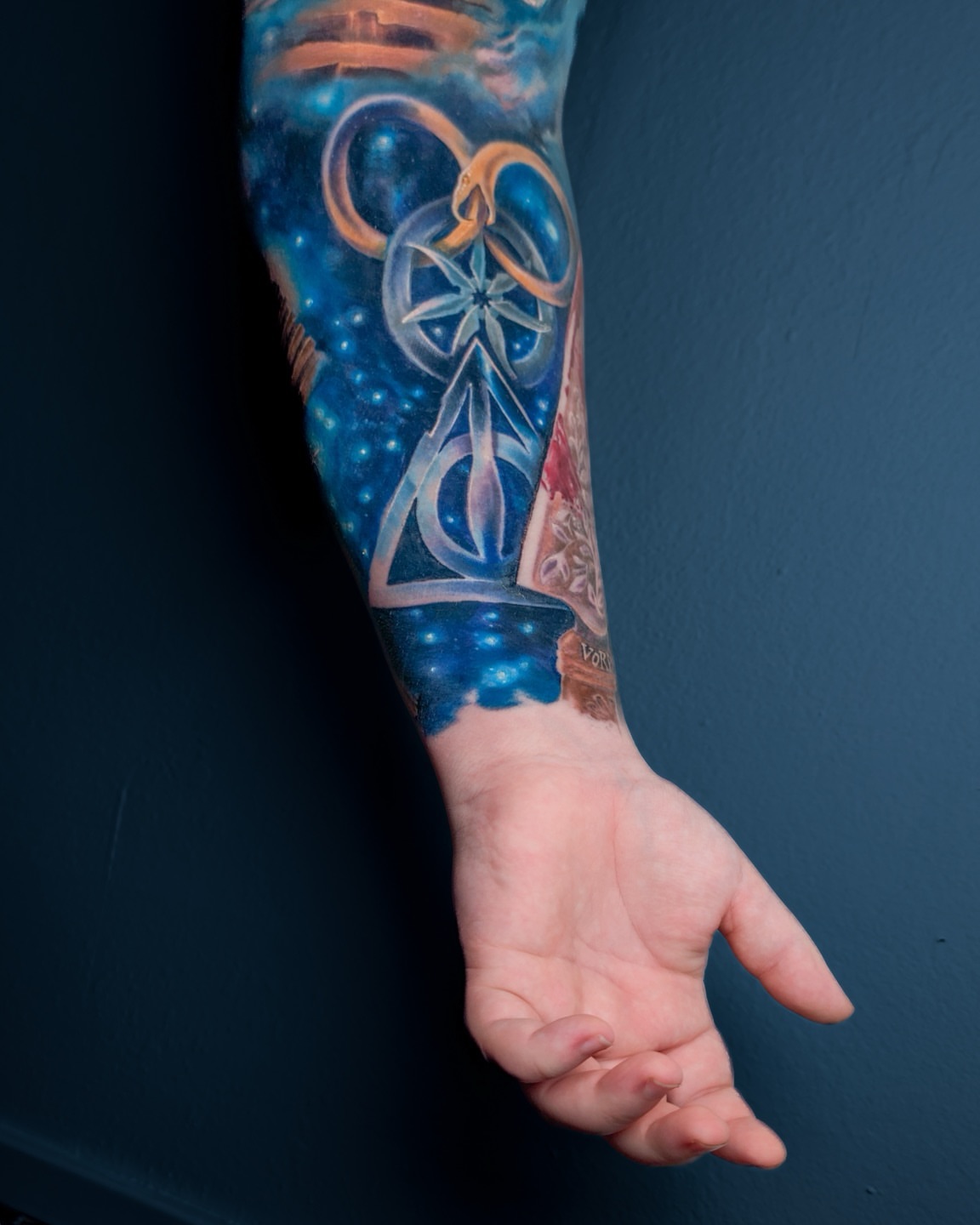 Galaxy and celestial symbols dotwork tattoo on the forearm by Amy Zager