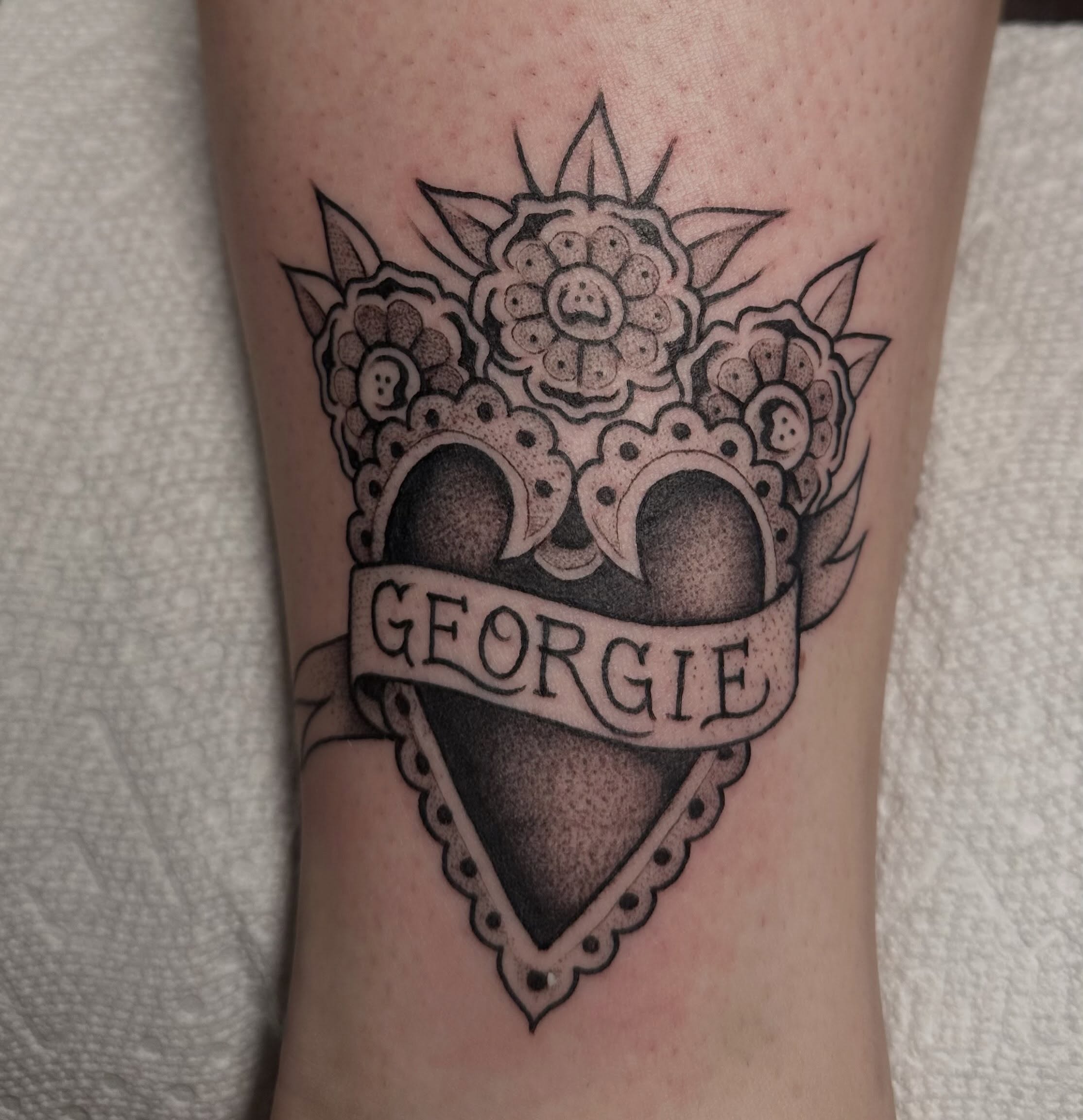 Heart with floral crown American traditional tattoo on the forearm by Lia Massari