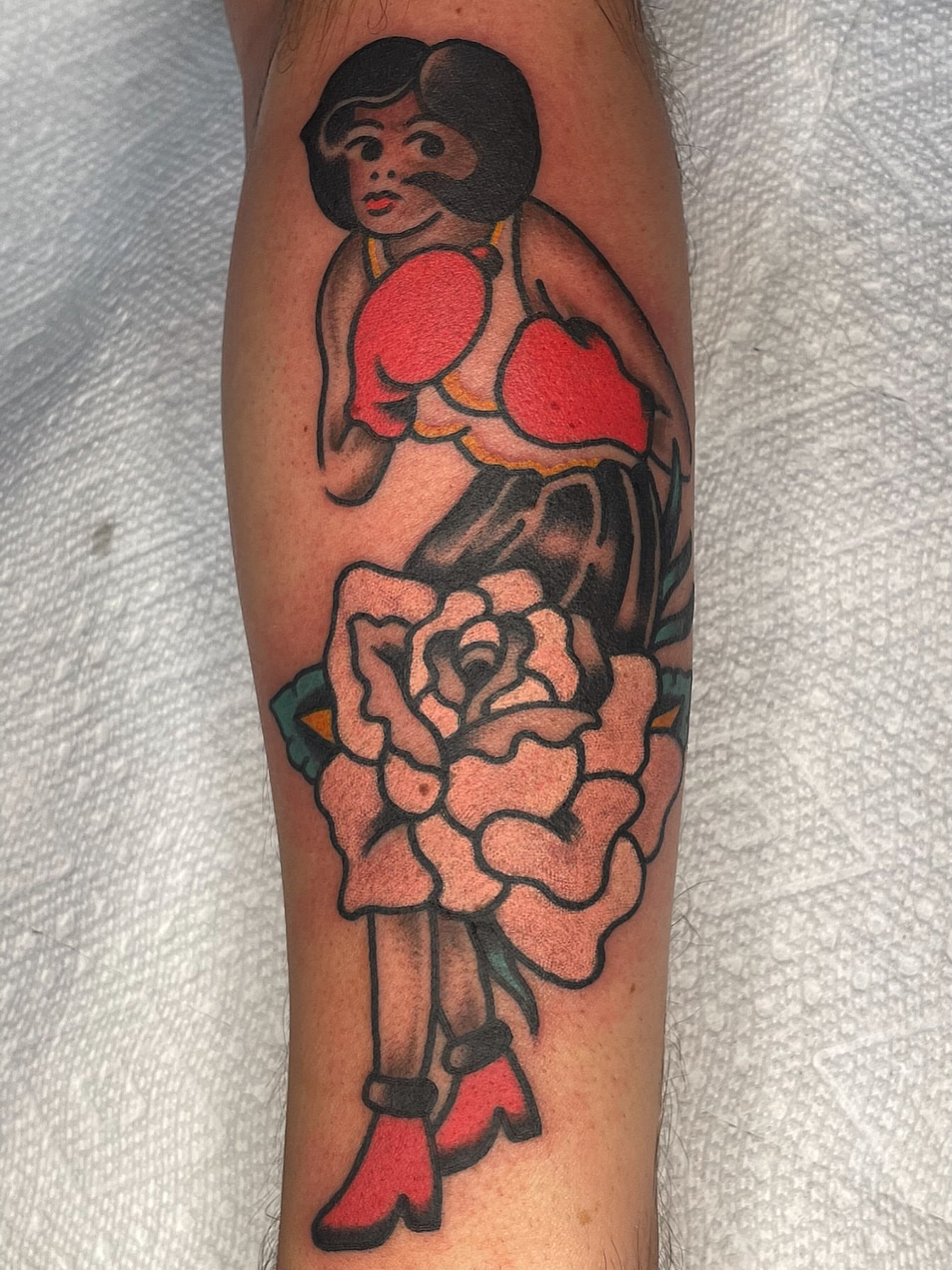 Woman with rose American traditional tattoo on the forearm by Nicholas M. Passeri