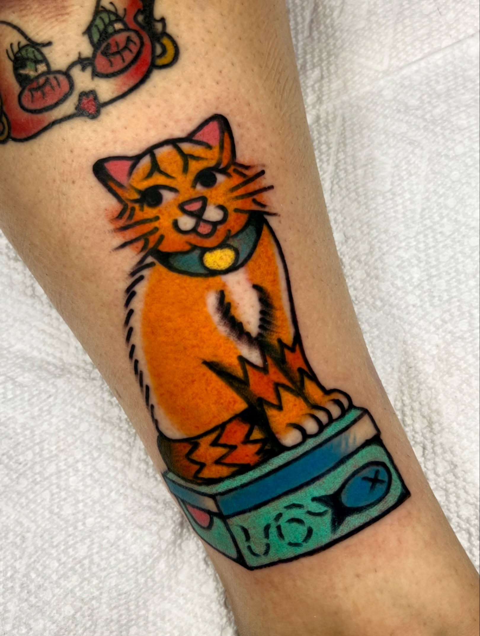 Cat American traditional tattoo on the forearm by Sierra Mack