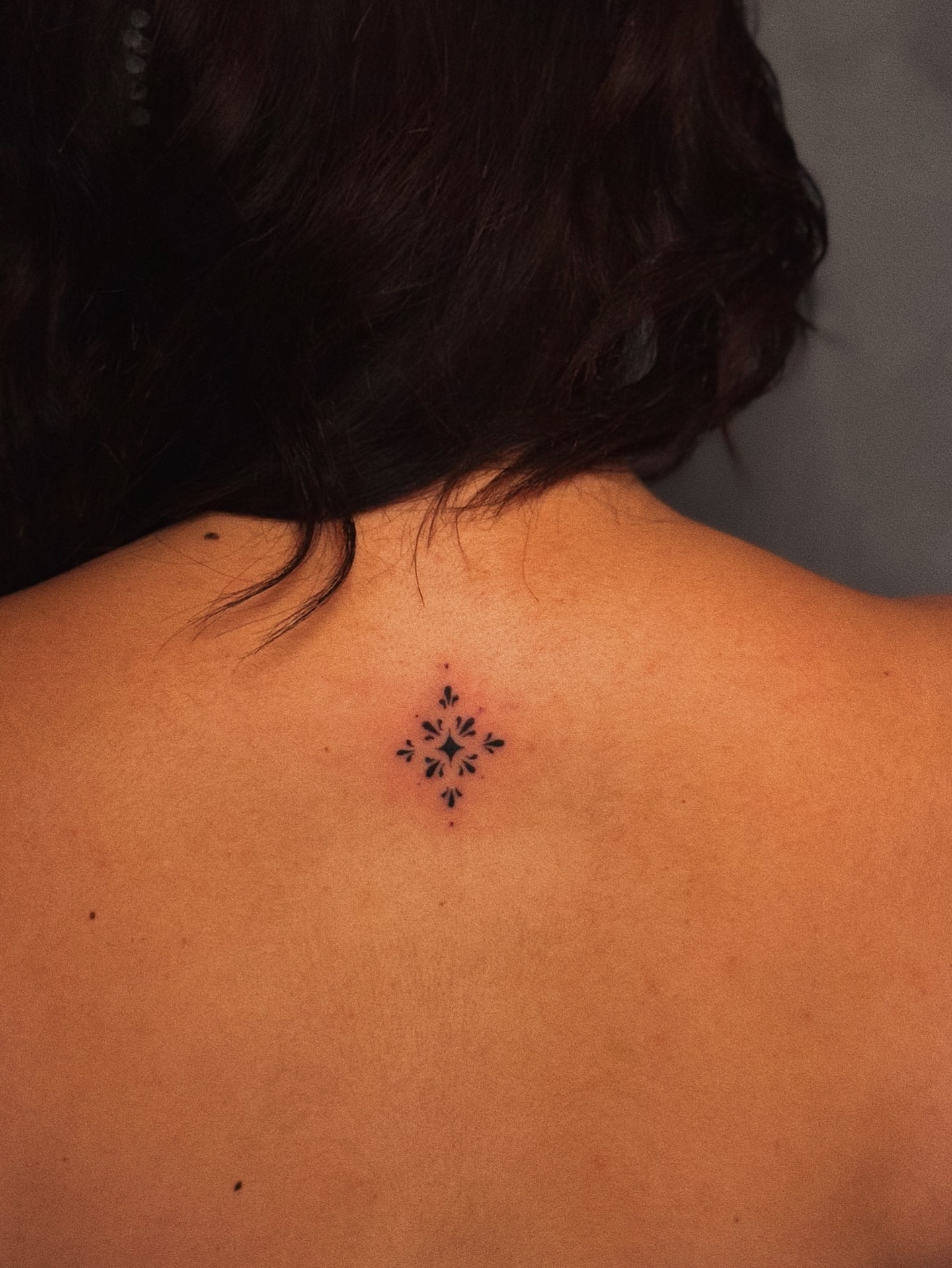 Snowflake geometric tattoo on the back by Luisa Duarte
