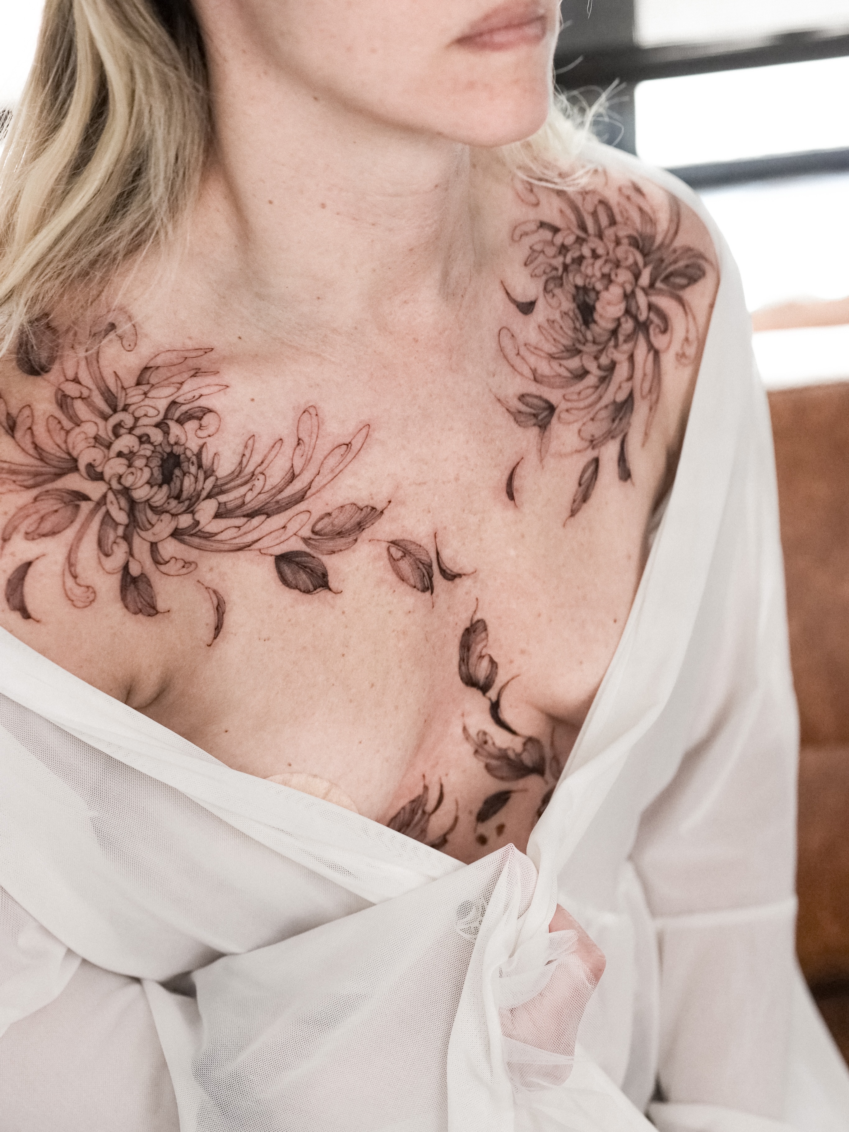 Chrysanthemum black and grey tattoo on the chest by Maria