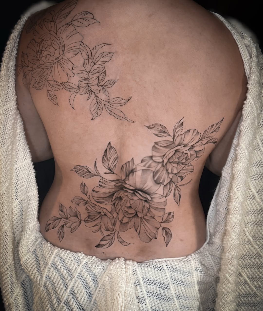 Floral black and grey tattoo on the back by Jennifer Ramirez