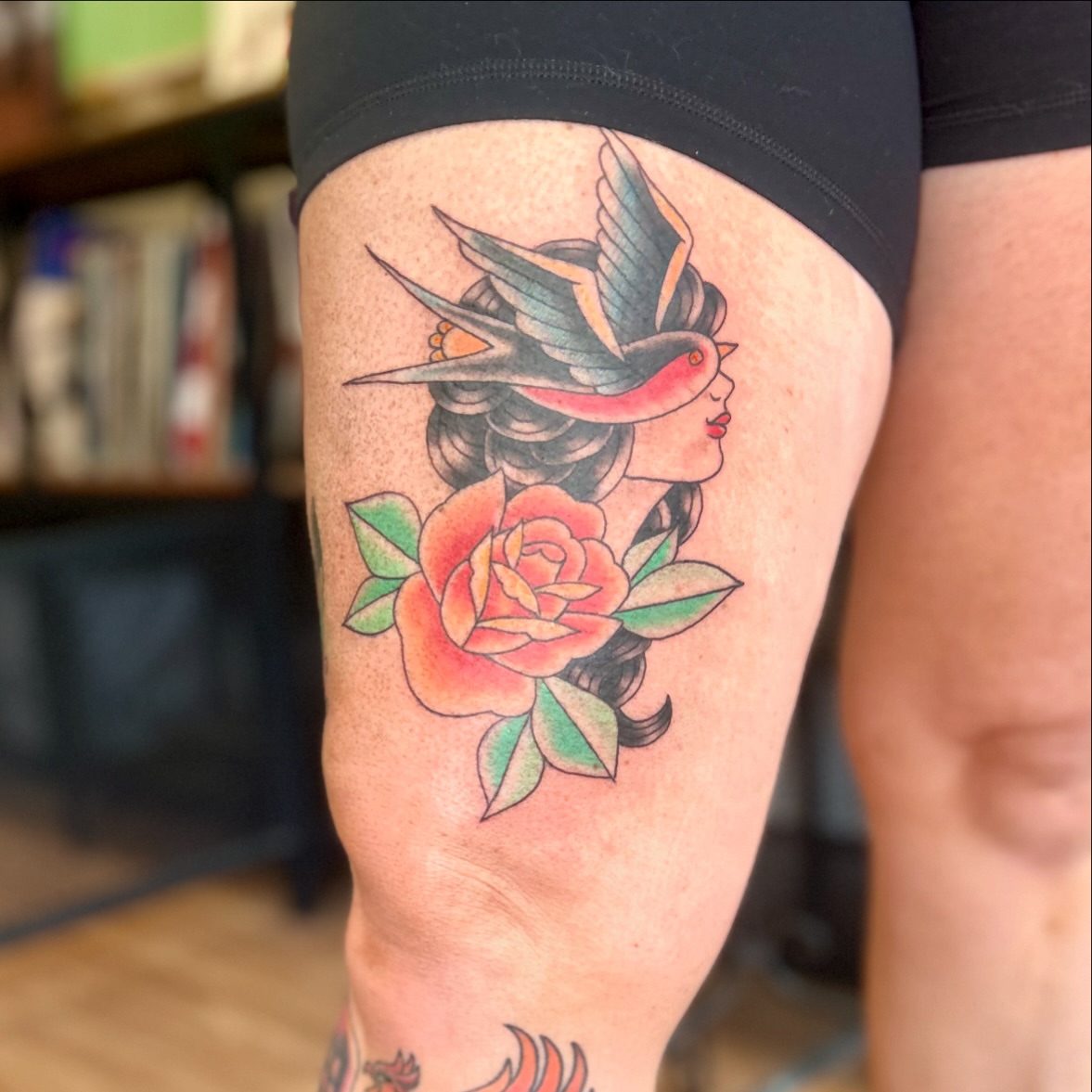 Bird and rose American traditional tattoo on the thigh by Tori Magill