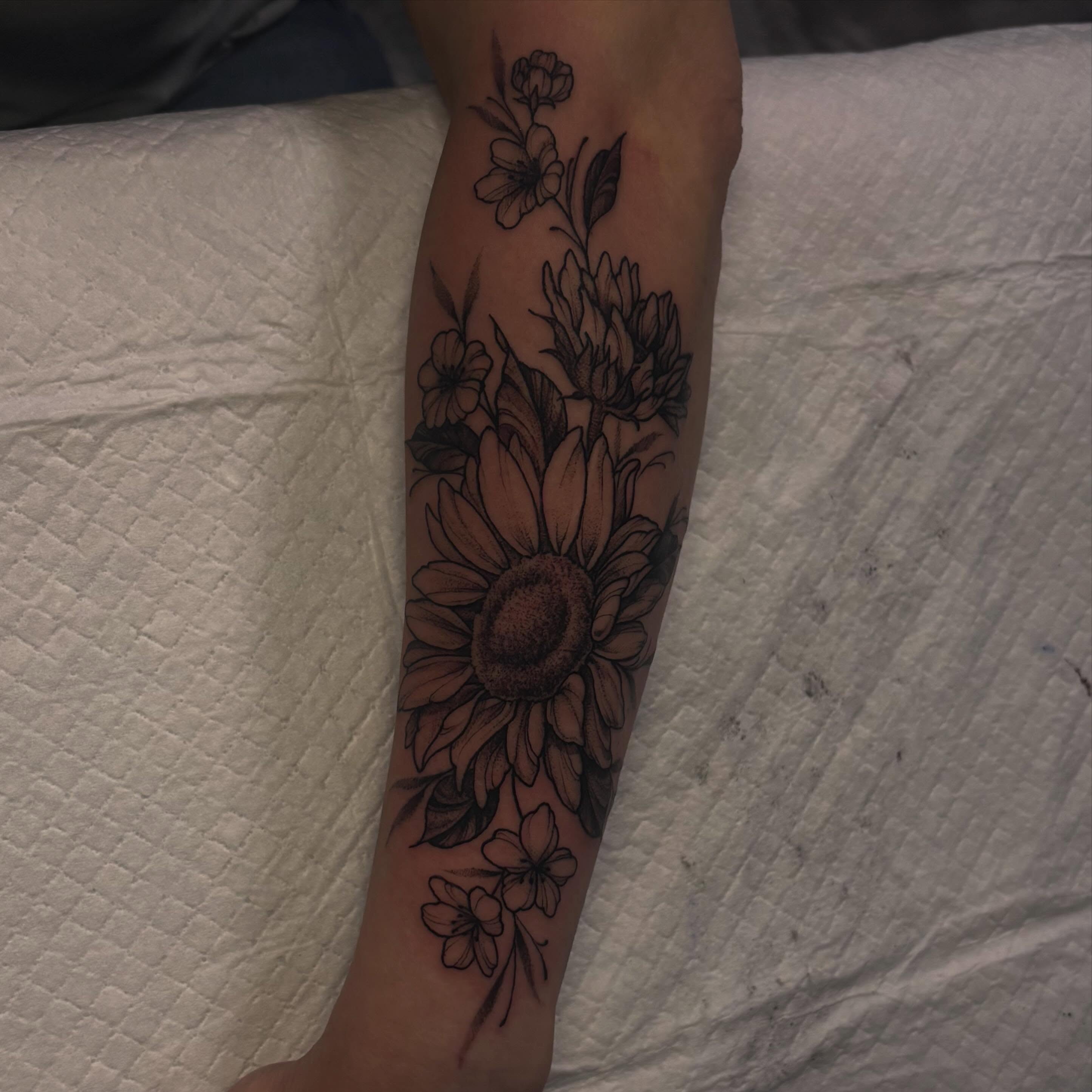 Sunflower and flowers black and grey tattoo on the forearm by Sydney Dixon, Sacramento, California