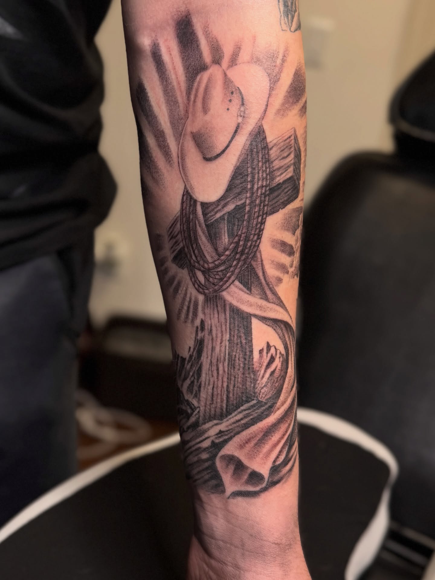 Cowboy black and grey tattoo on the forearm by Jarrod Gatzke
