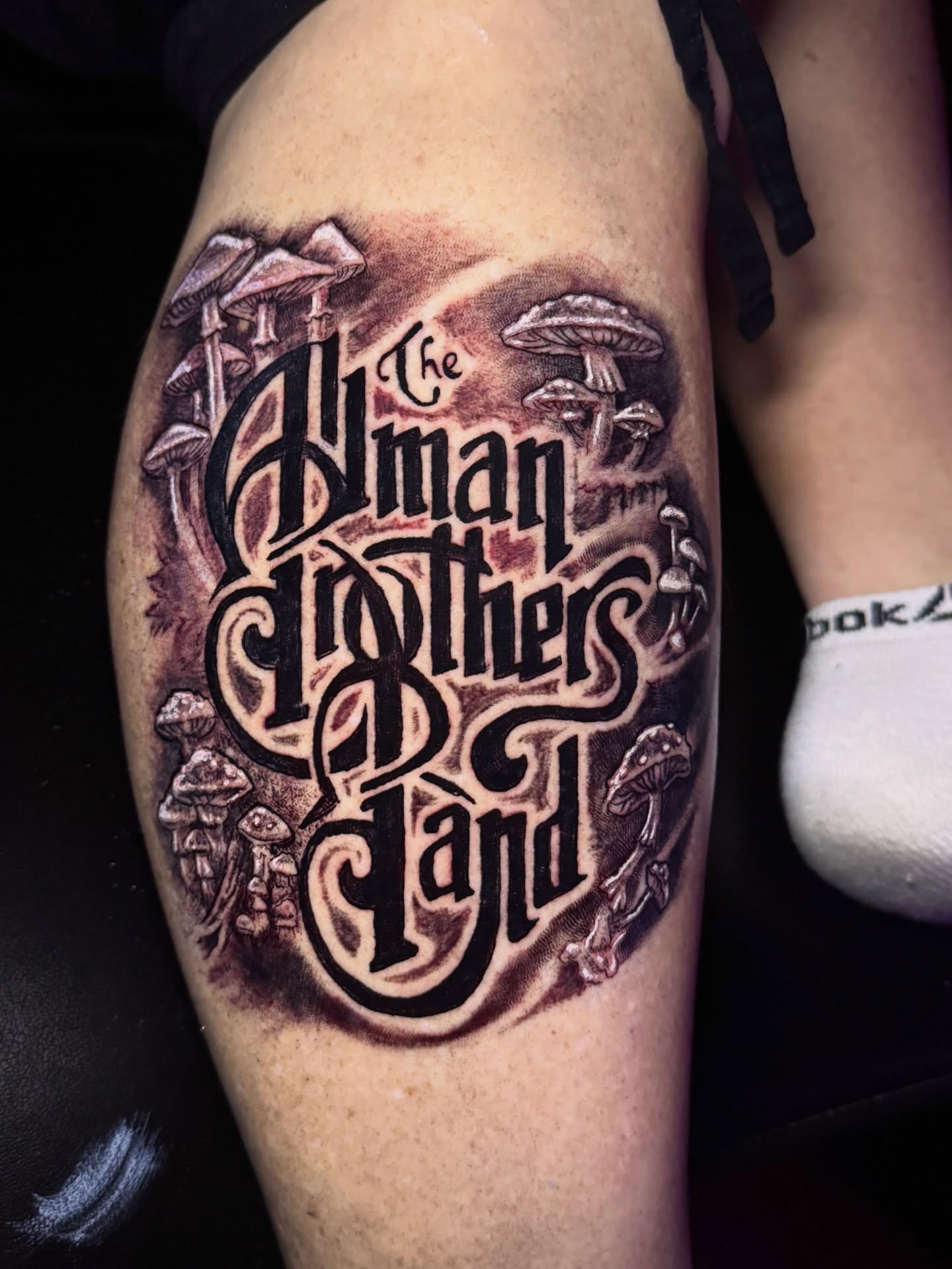 Mushroom and script lettering script tattoo on the forearm by Jarrod Gatzke