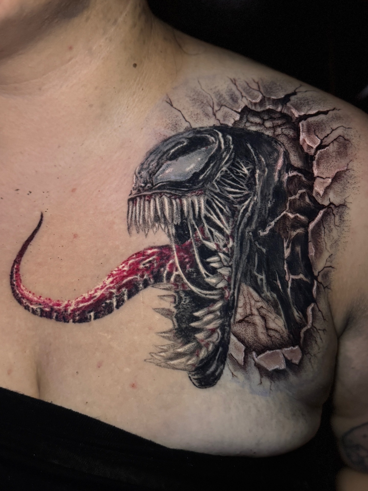 Venom realism tattoo on the chest by Jarrod Gatzke