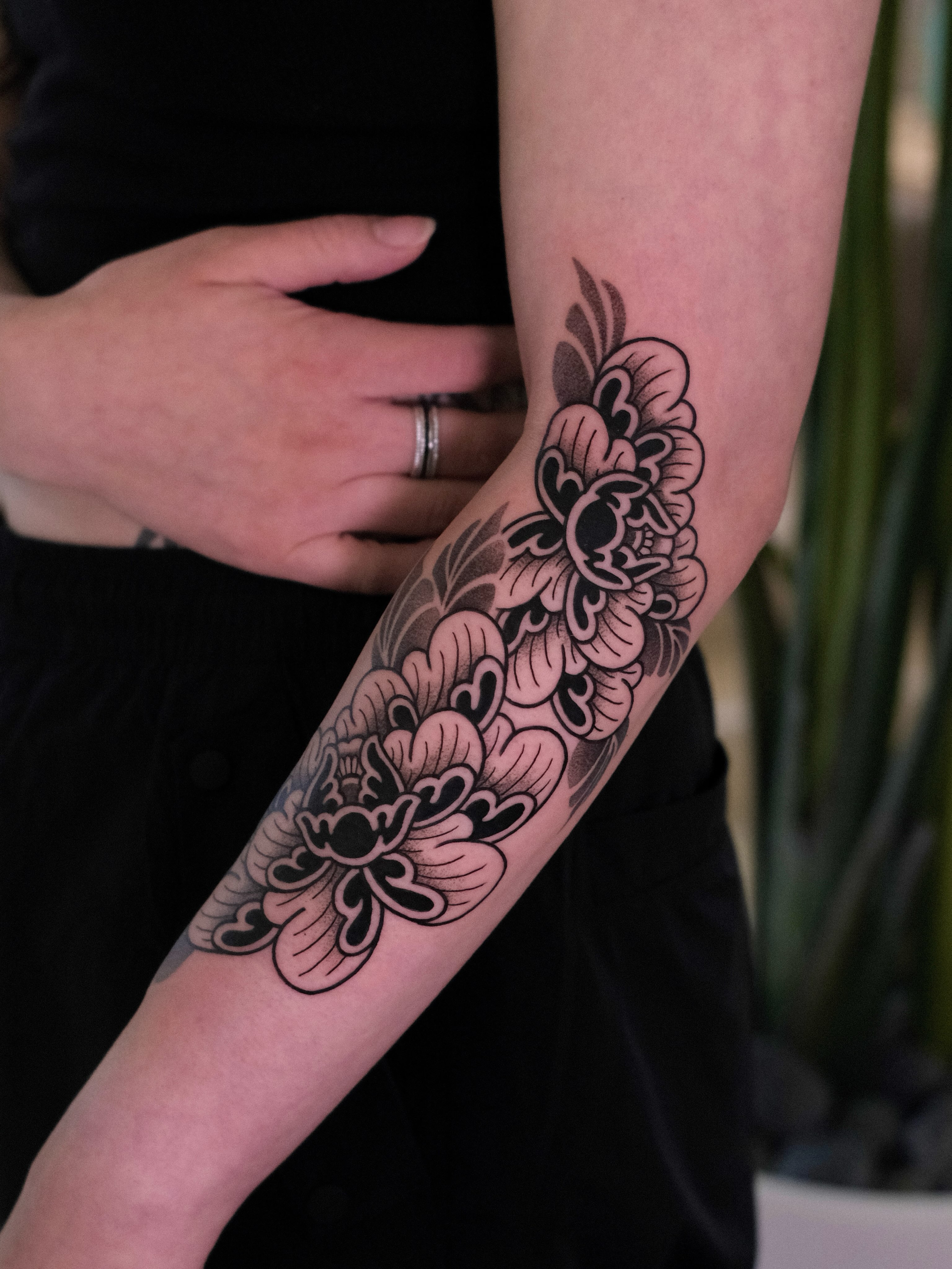 Floral design black and grey tattoo on the forearm by seattle tattoo artist