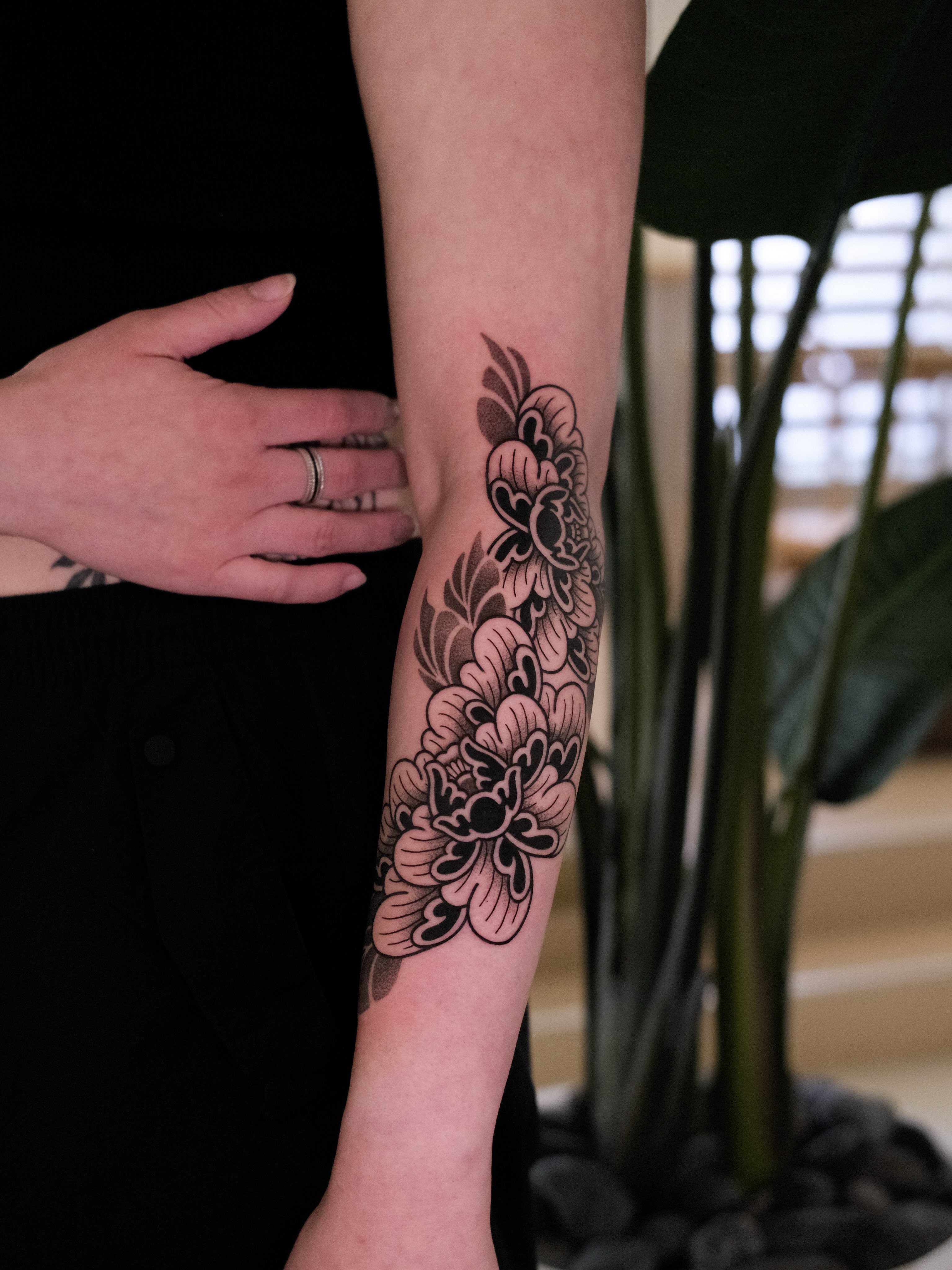 Floral design black and grey tattoo on the forearm by seattle tattoo artist