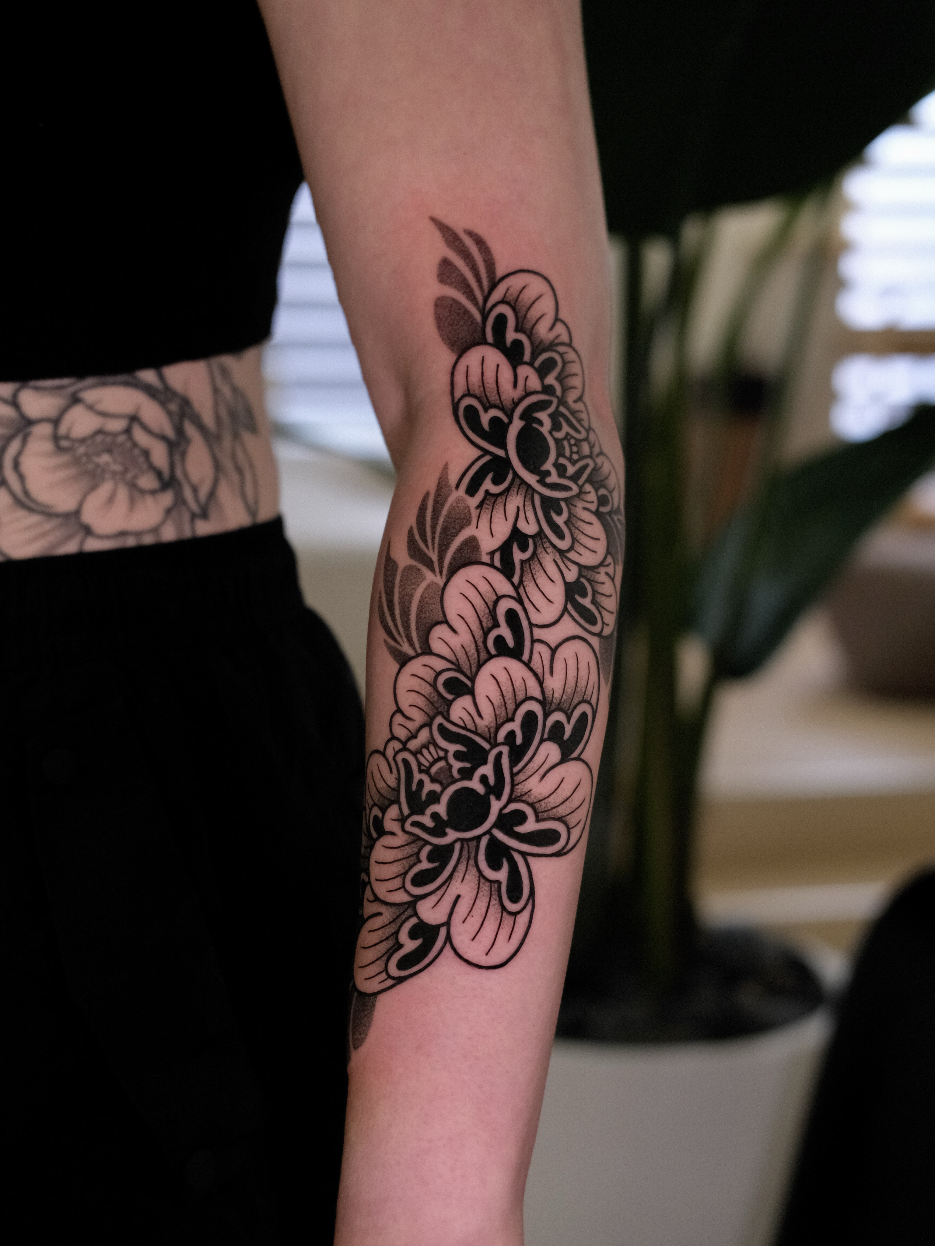 Floral pattern black and grey tattoo on the forearm by seattle tattoo artist