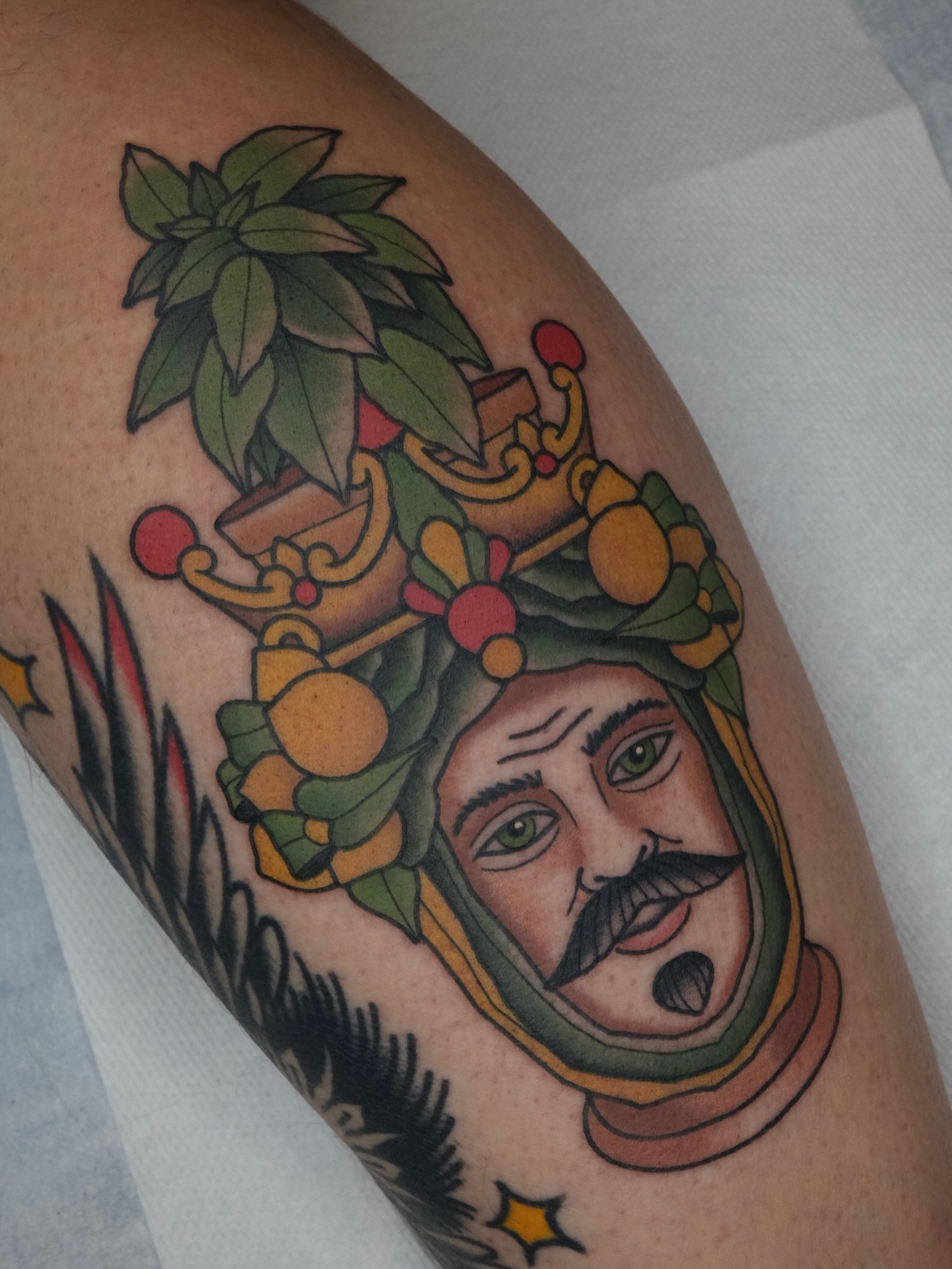Man with fruit crown American traditional tattoo on the forearm by James Maxwell