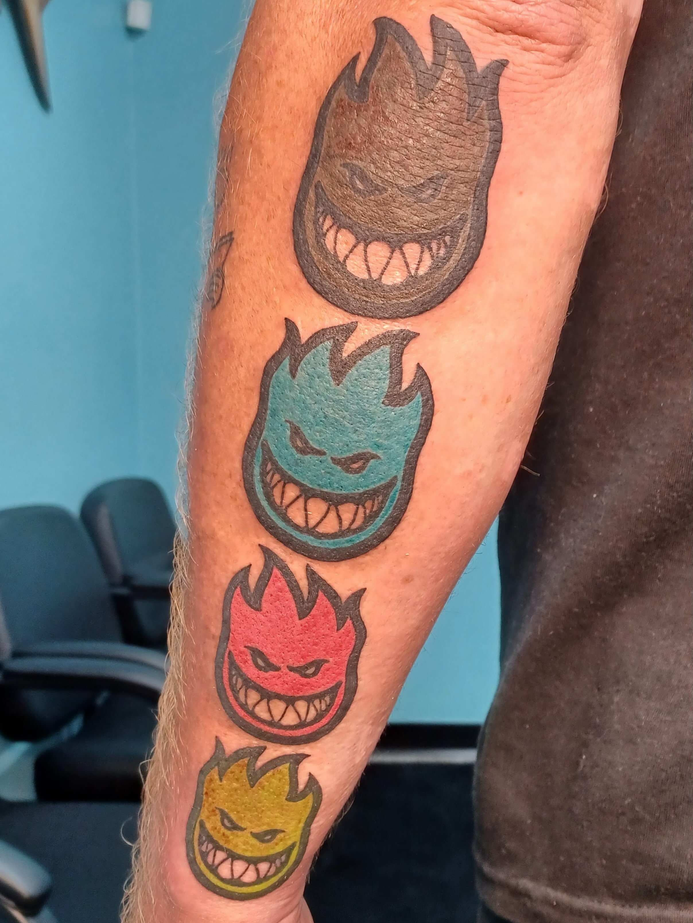 Flame ghost heads neo-traditional tattoo on the forearm by Abi