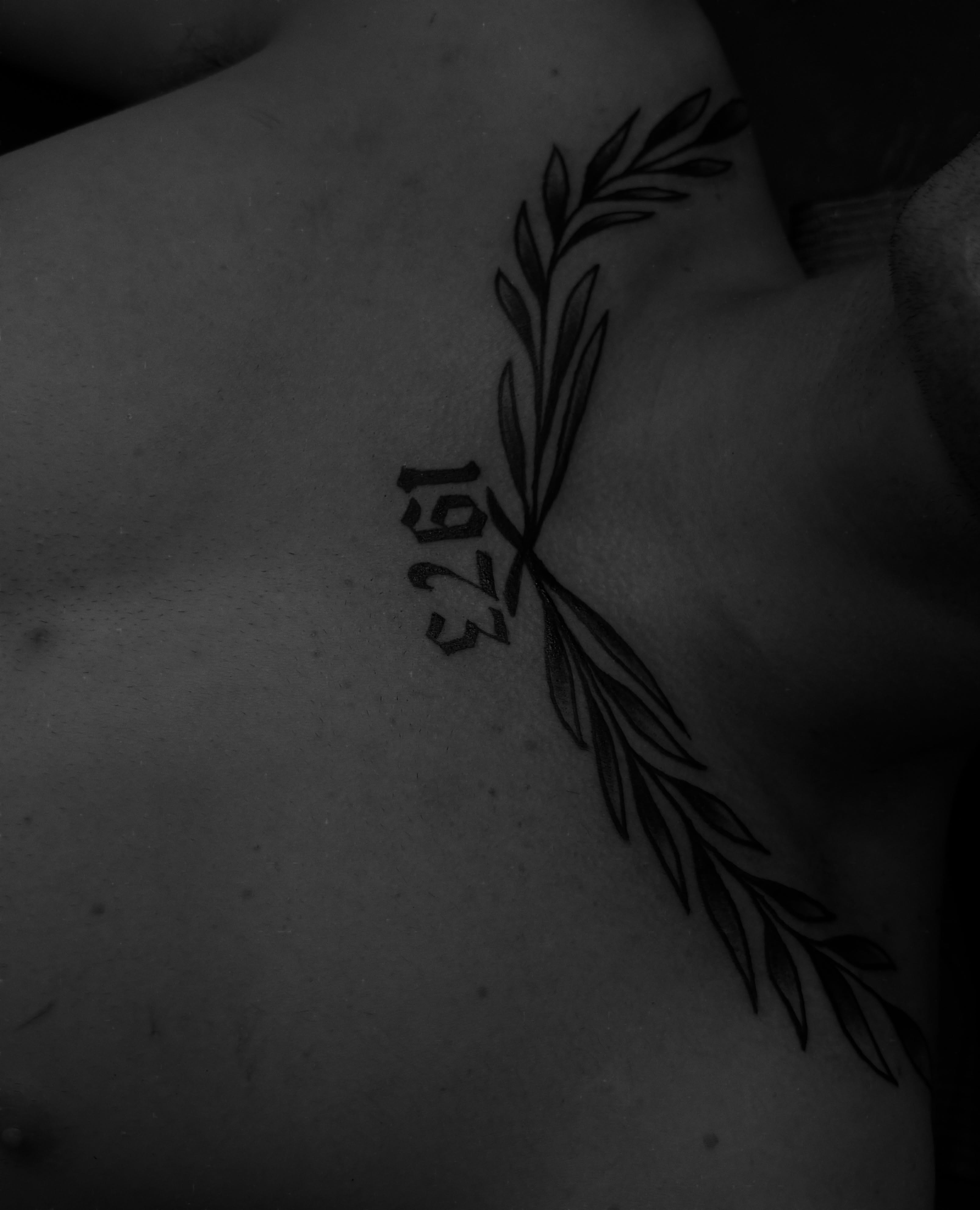 Olive branch with numbers black and grey tattoo on the chest by Casey - Tattooer, Salem, Massachusetts