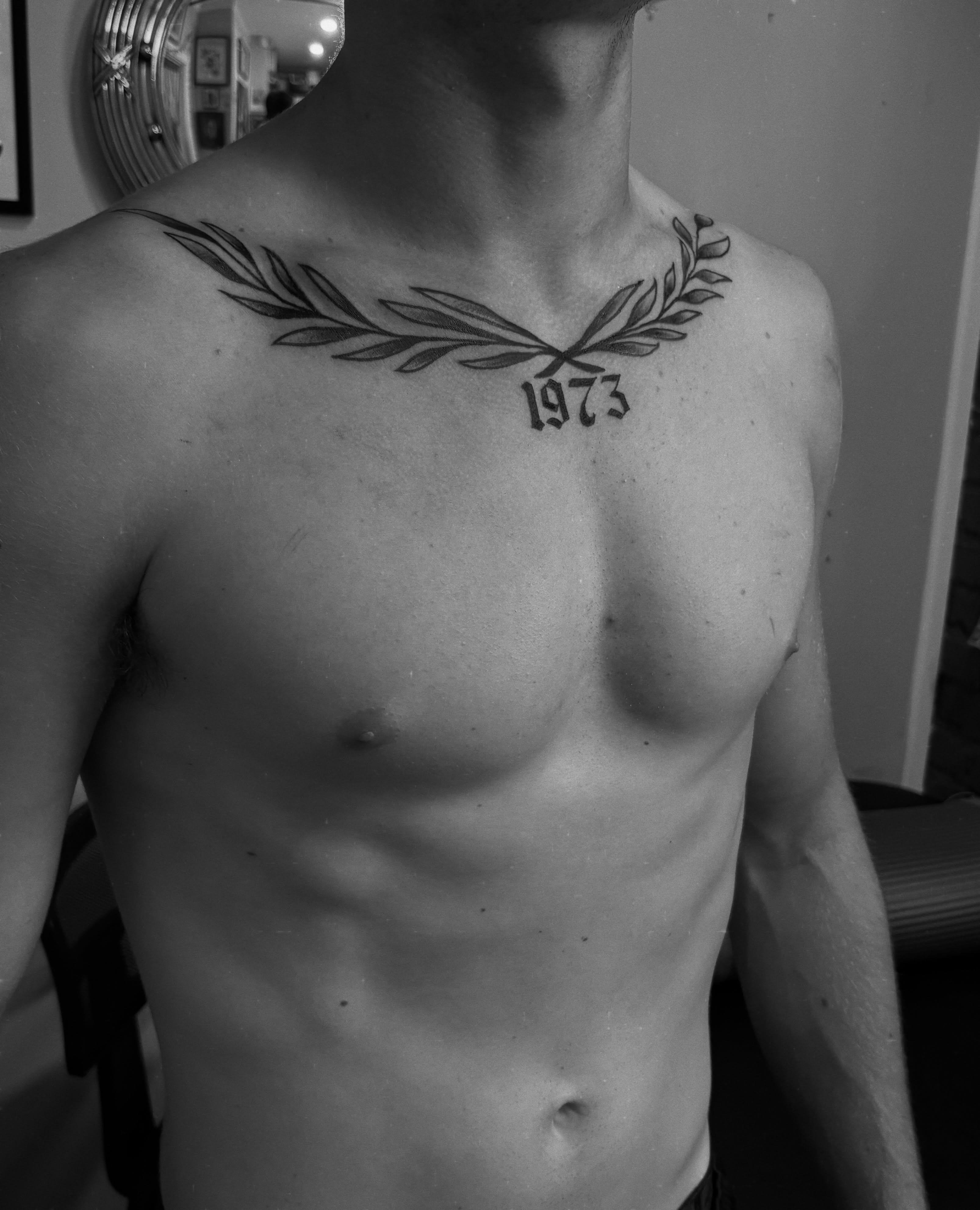 Olive branch black and grey tattoo on the chest by Casey - Tattooer, Salem, Massachusetts