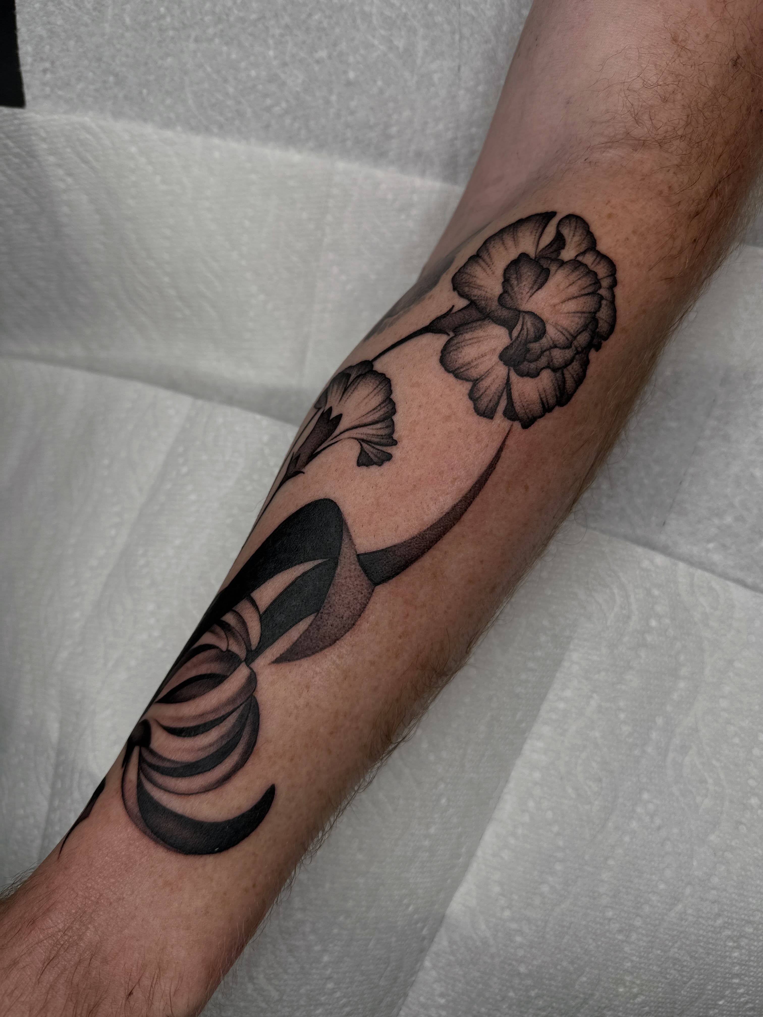Flowers black and grey tattoo on the forearm by Aleksandra