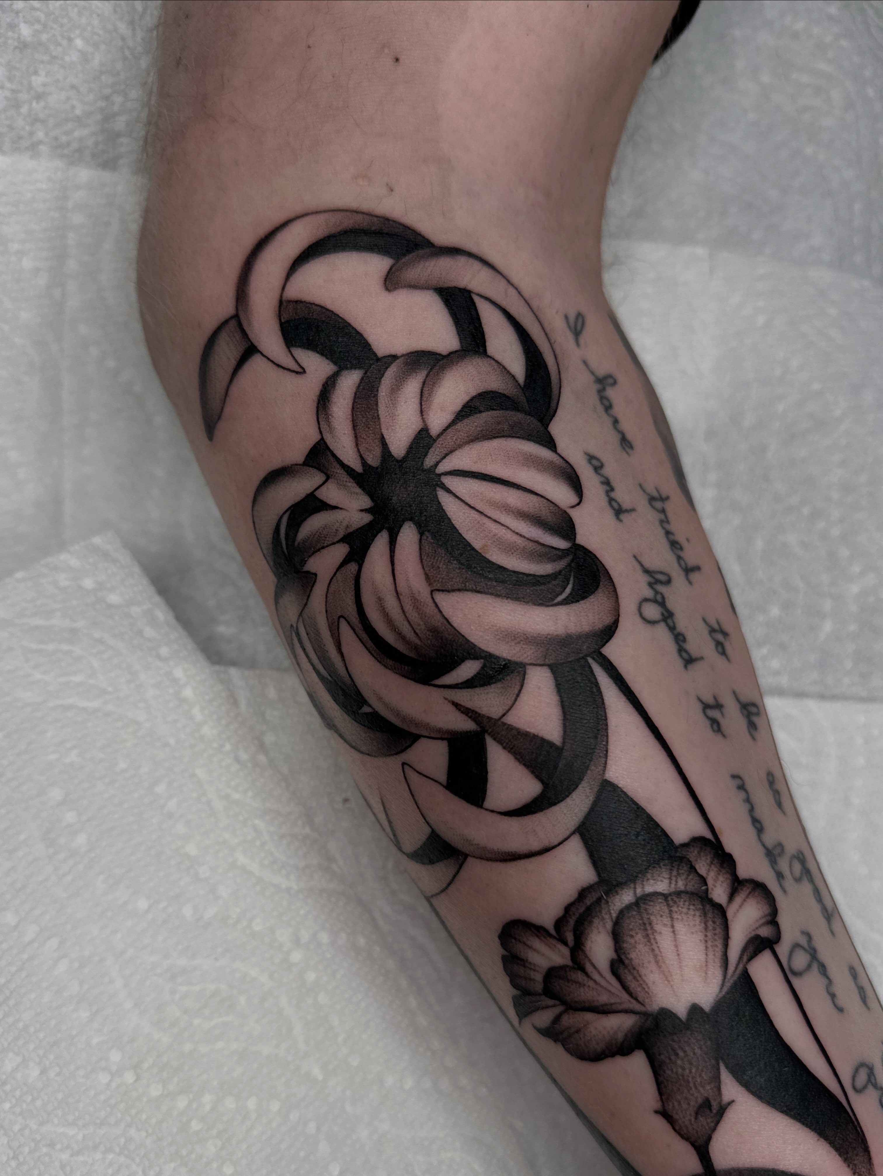 Abstract floral design black and grey tattoo on the forearm by Aleksandra