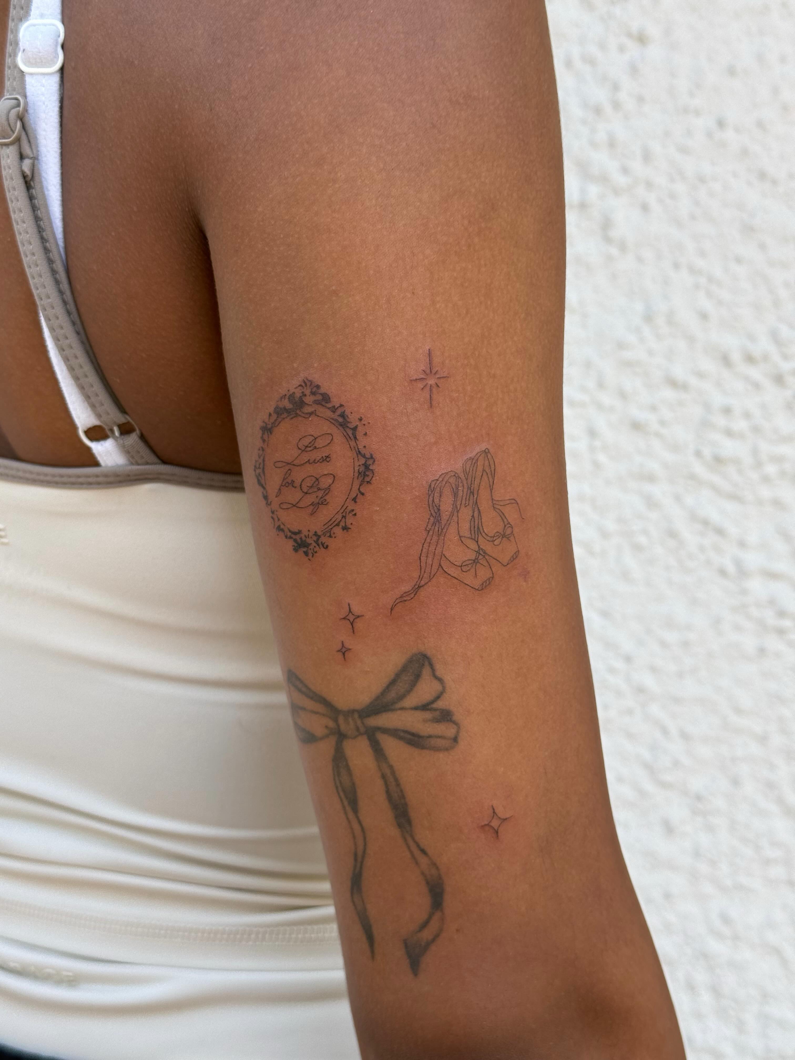Bow and ribbon black and grey tattoo on the forearm by TATTOO & PIERCING ARTIST ₊˚⊹ ᰔ