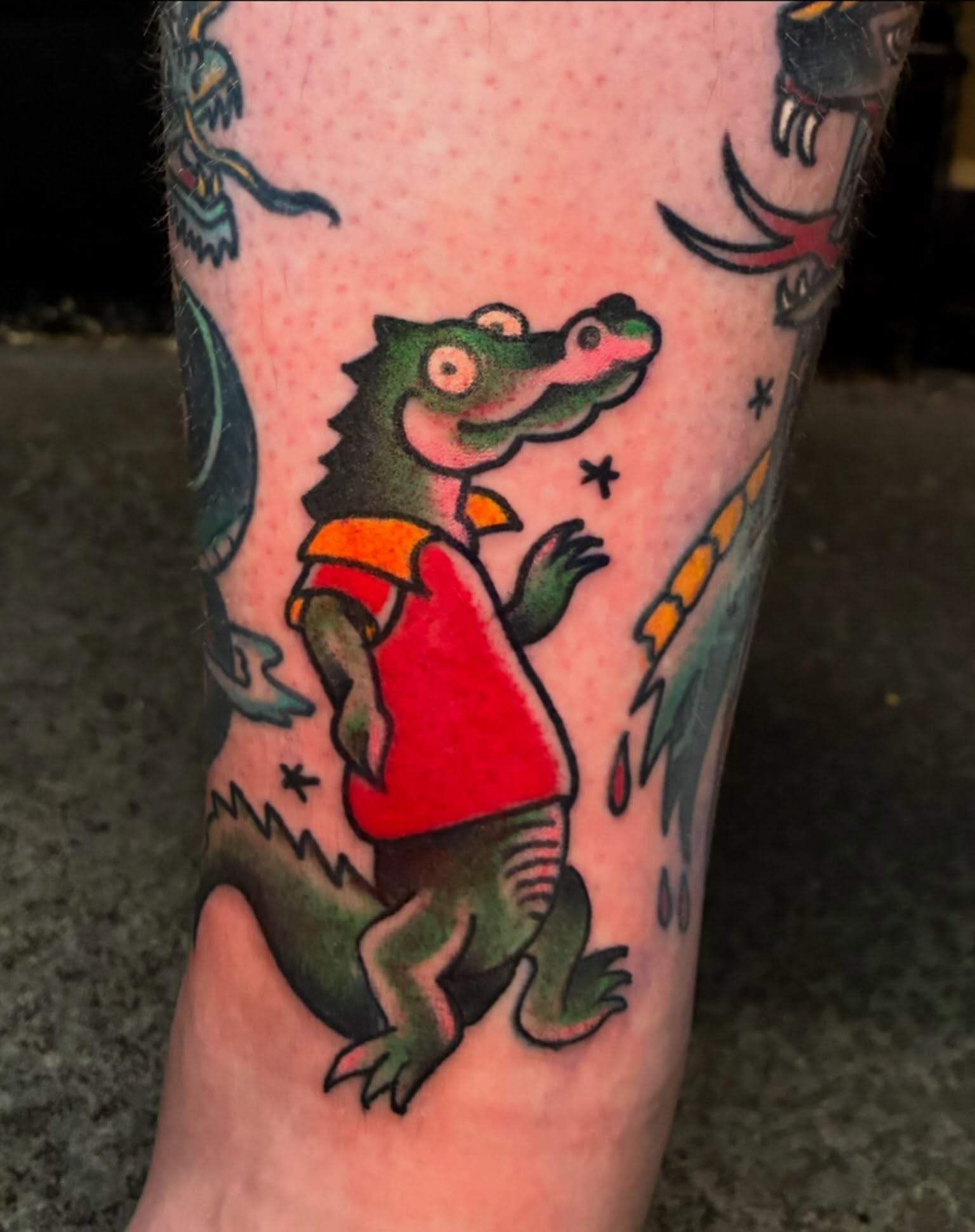 Alligator wearing shirt American traditional tattoo on the forearm by Joey Knuckles