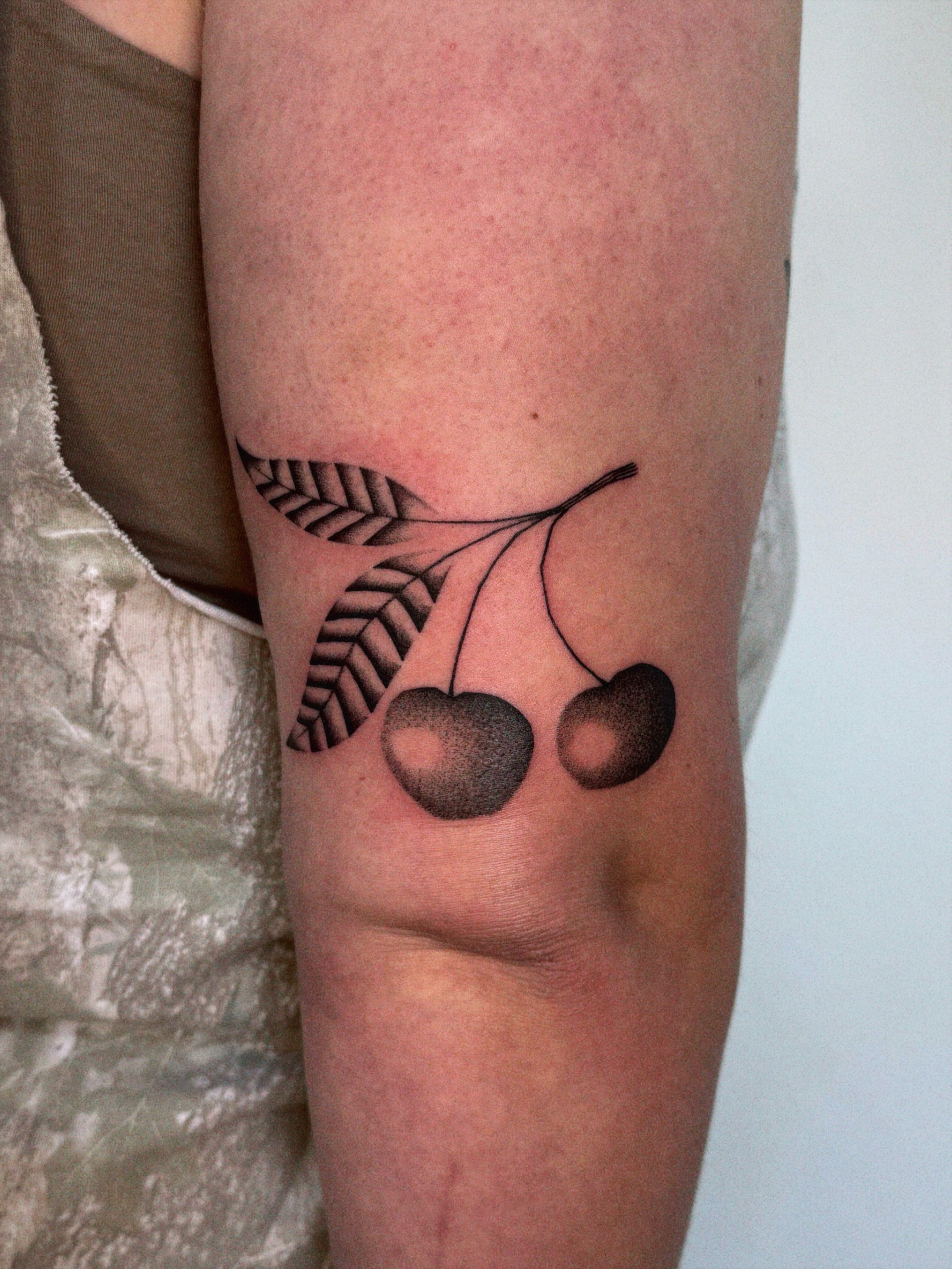 Cherries black and grey tattoo on the forearm by @inkshame