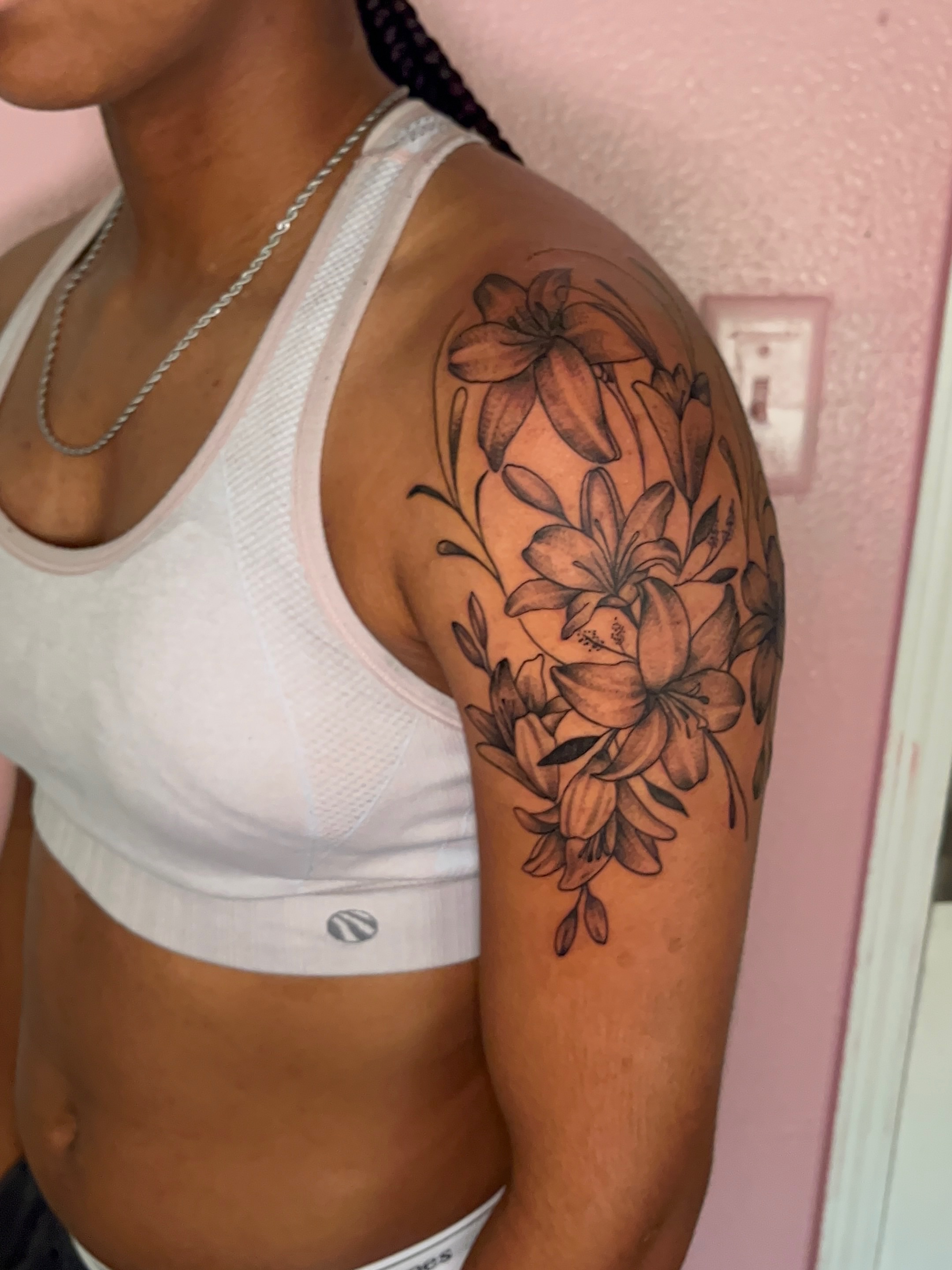 Lilies black and grey tattoo on the shoulder by The inspo