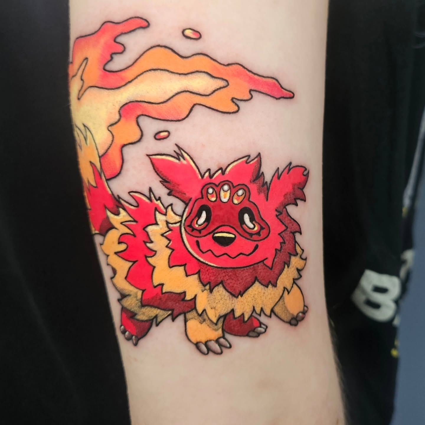 Flame-monster new school tattoo on the forearm by Gray