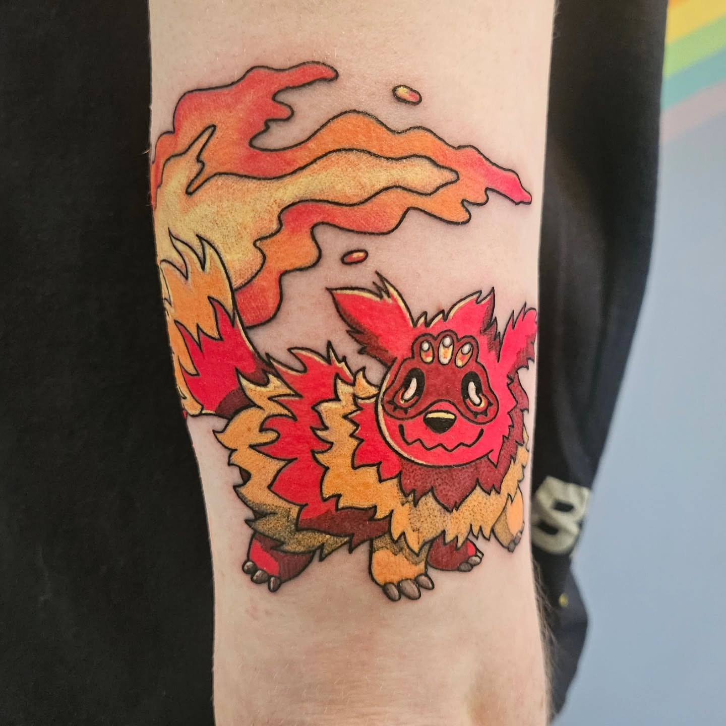 Flame monster dotwork tattoo on the forearm by Gray