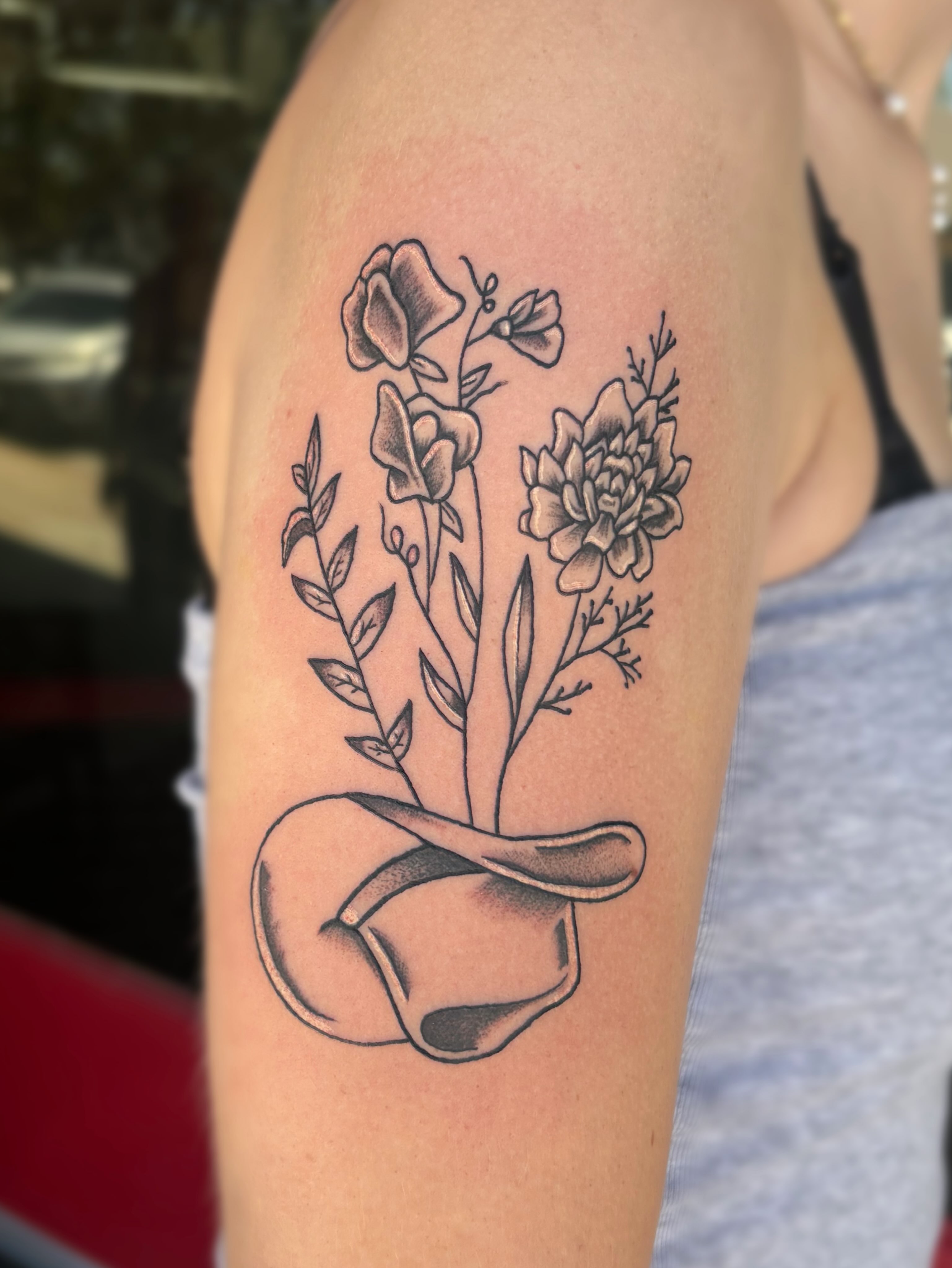 Flower bouquet black and grey tattoo on the forearm by Ava Brady Tattoos