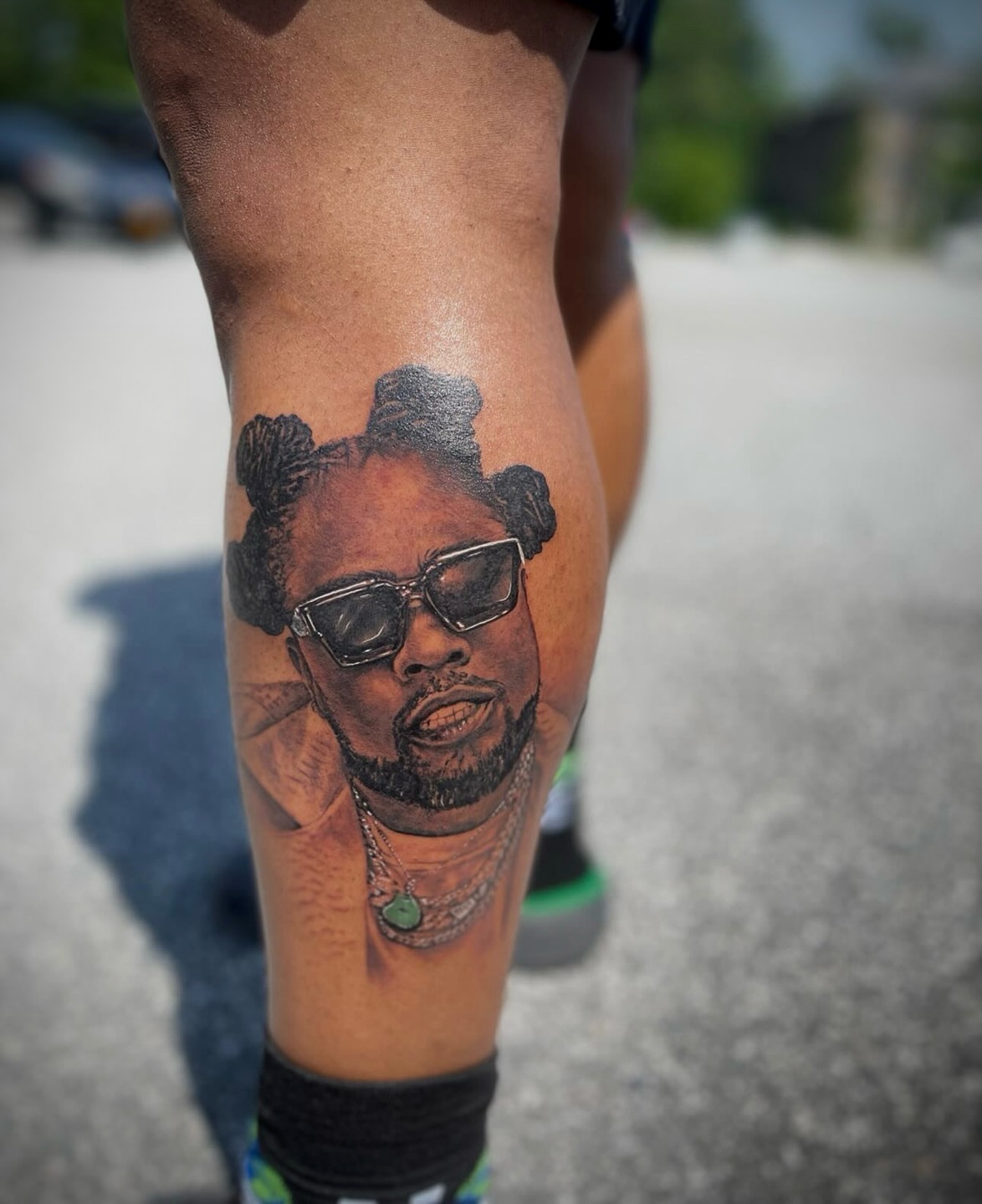 Rapper realism tattoo on the thigh by Ray Wiggins