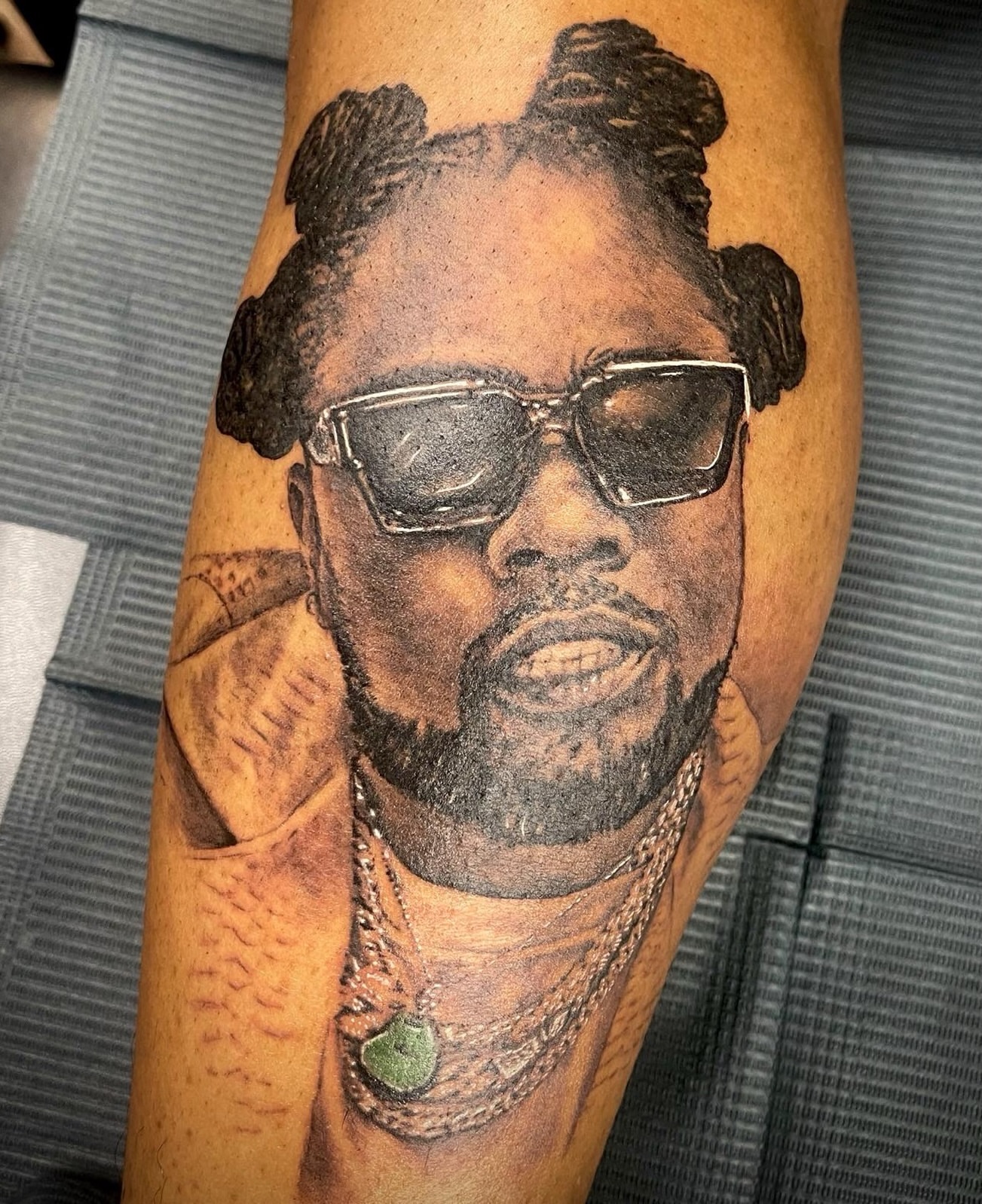 Portrait realism tattoo on the forearm by Ray Wiggins