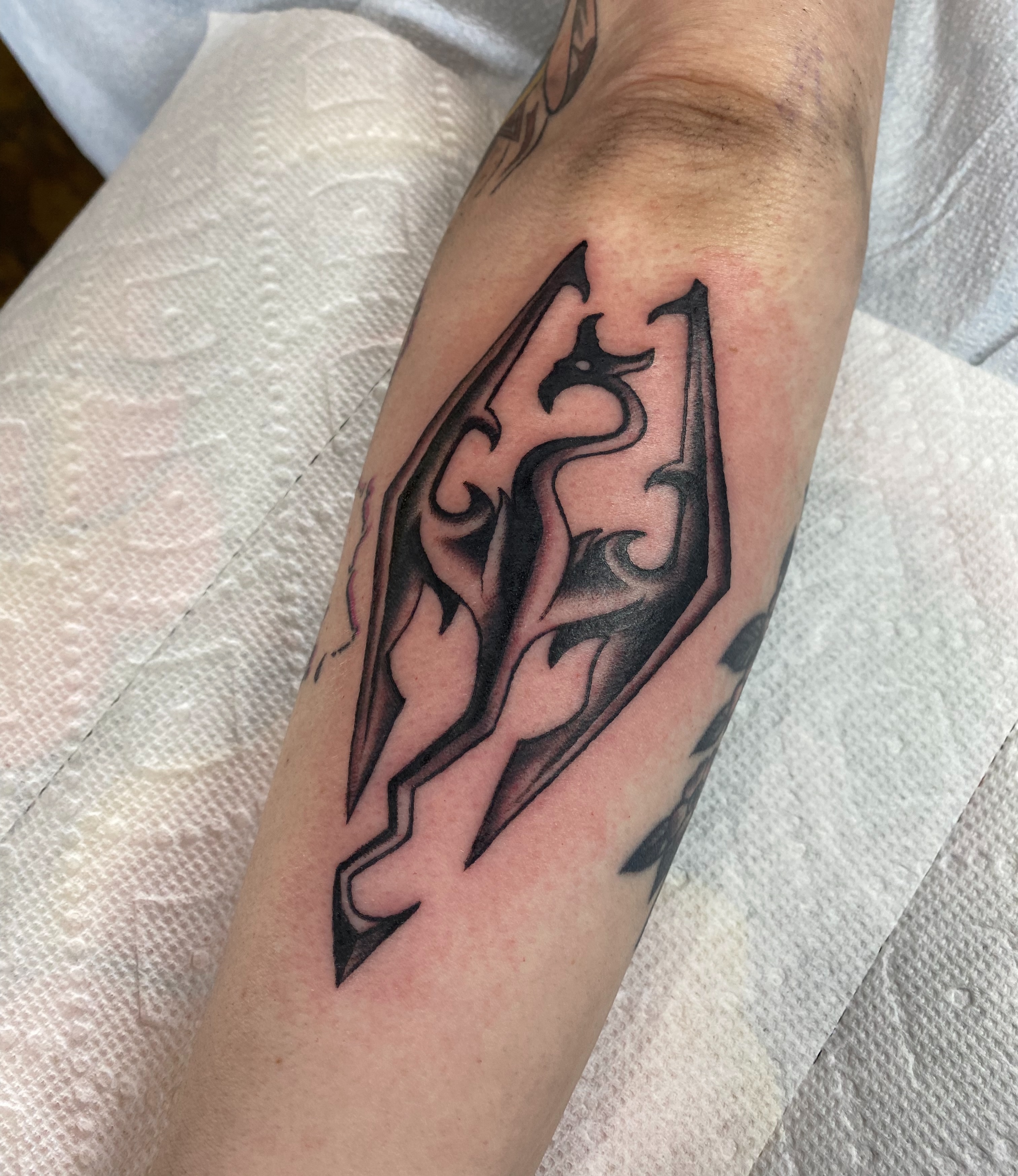 Abstract flame tribal tattoo on the forearm by Karl Hegwein, Portland, Oregon