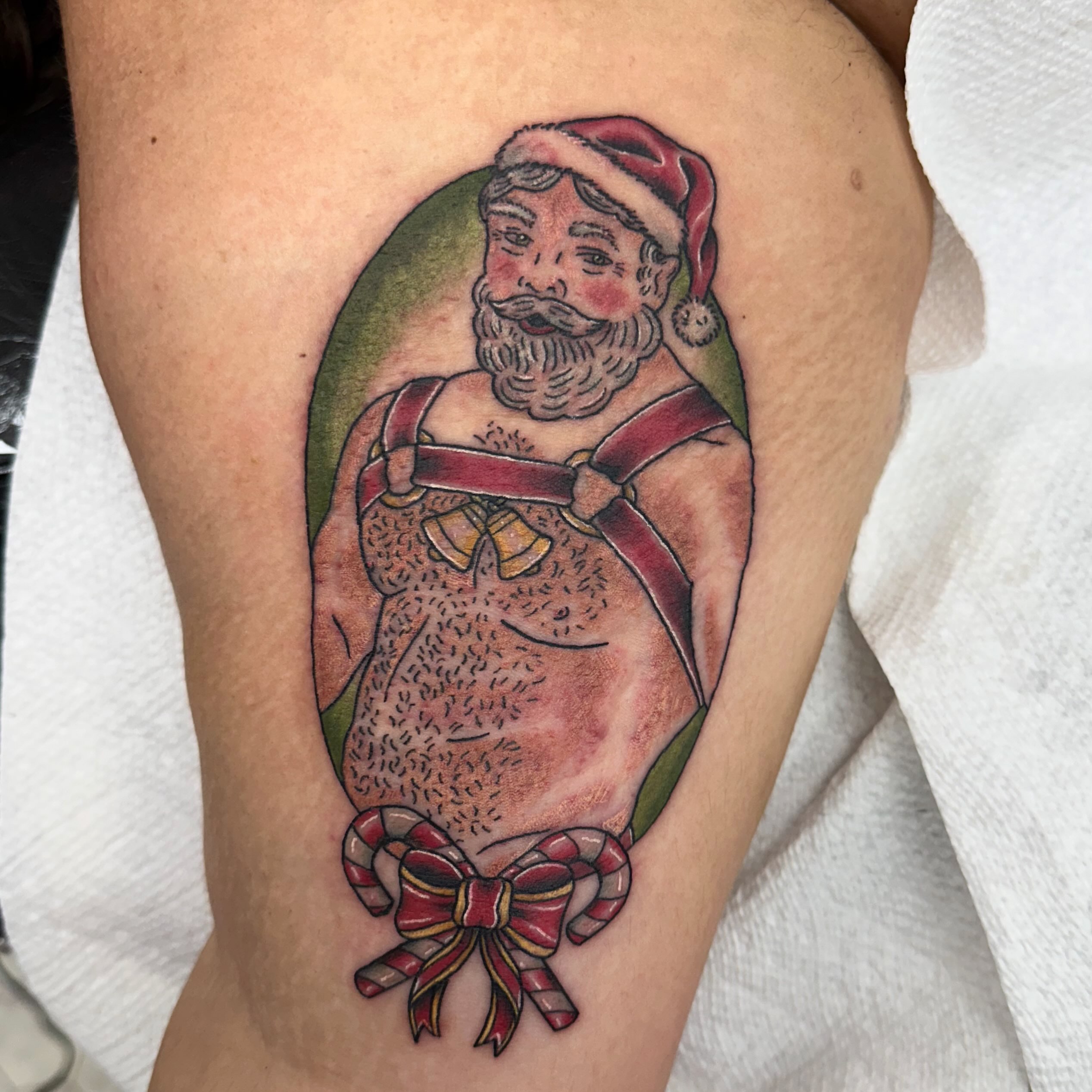 Santa Claus American traditional tattoo on the thigh by Nicki Hoverson