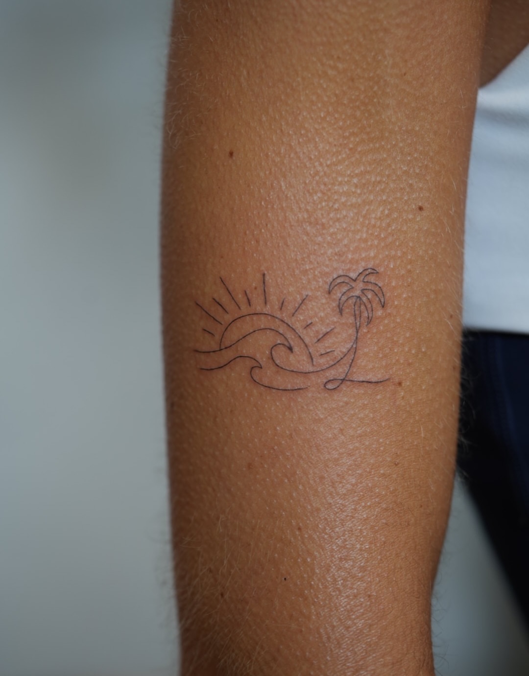 Sunset and palm tree minimalist tattoo on the forearm by 🤍 Sarah 🖤