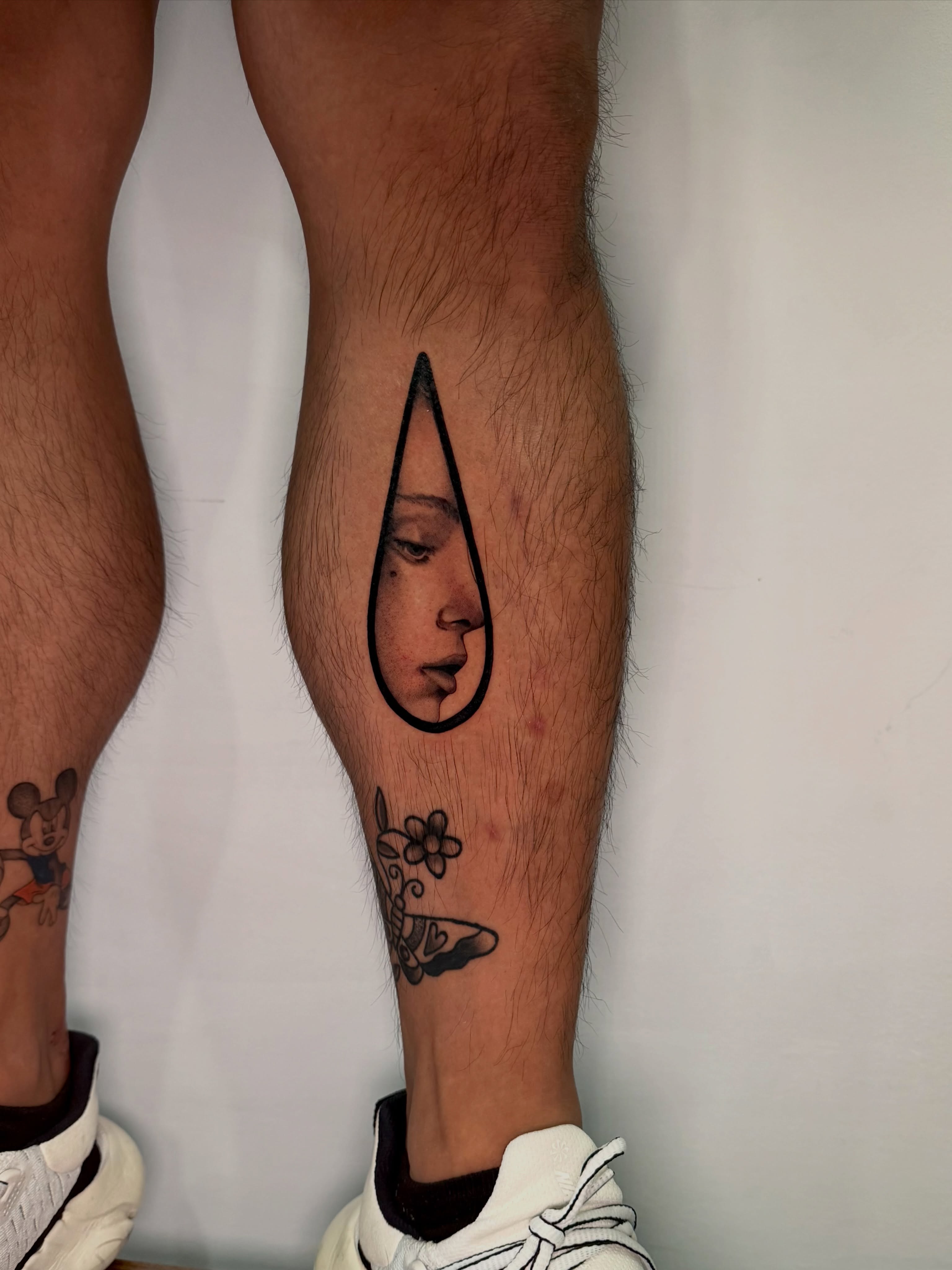 Teardrop with face realism tattoo on the calf by 𝘋𝘪𝘢𝘯𝘯𝘢