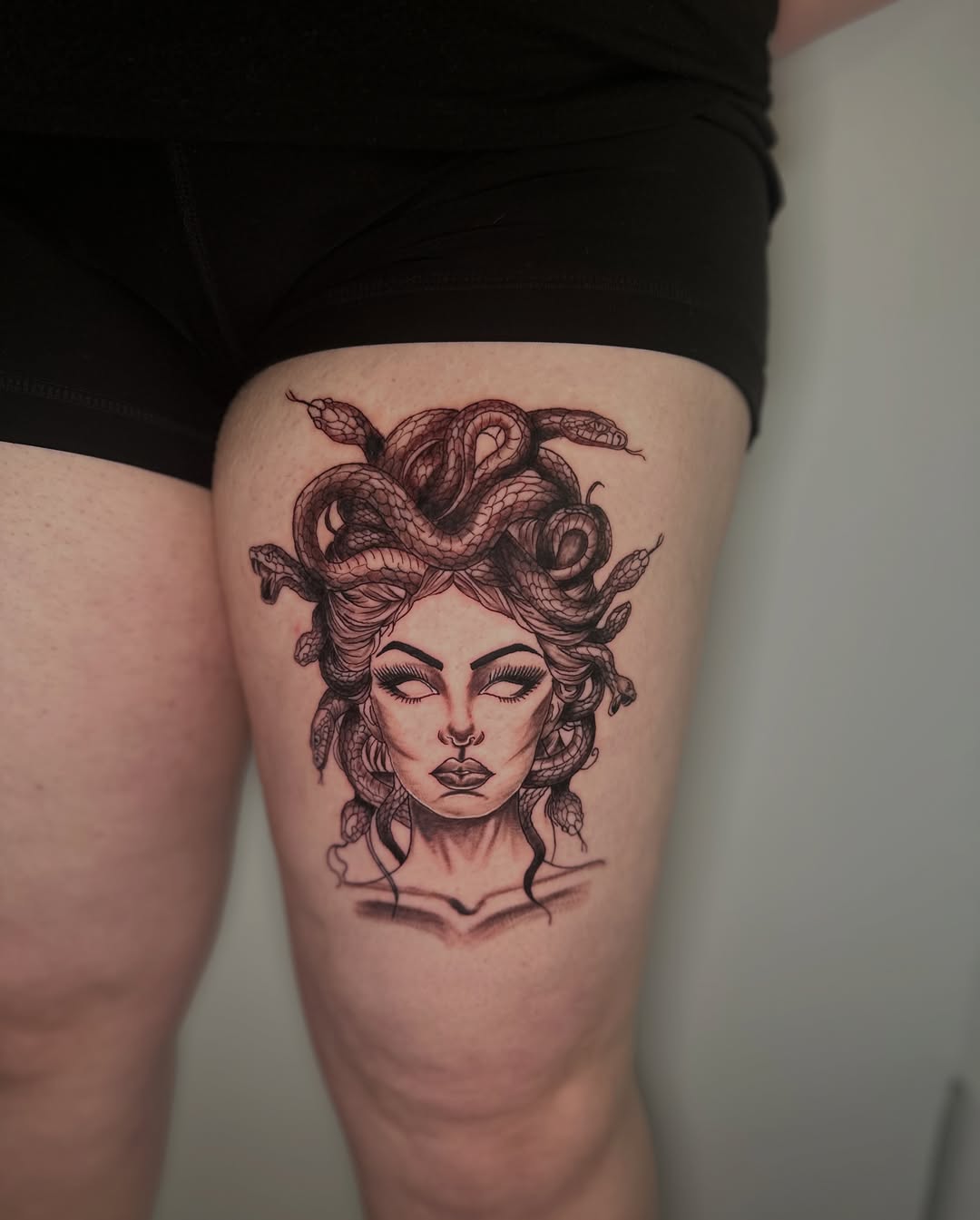 Medusa black and grey tattoo on the thigh by AJ