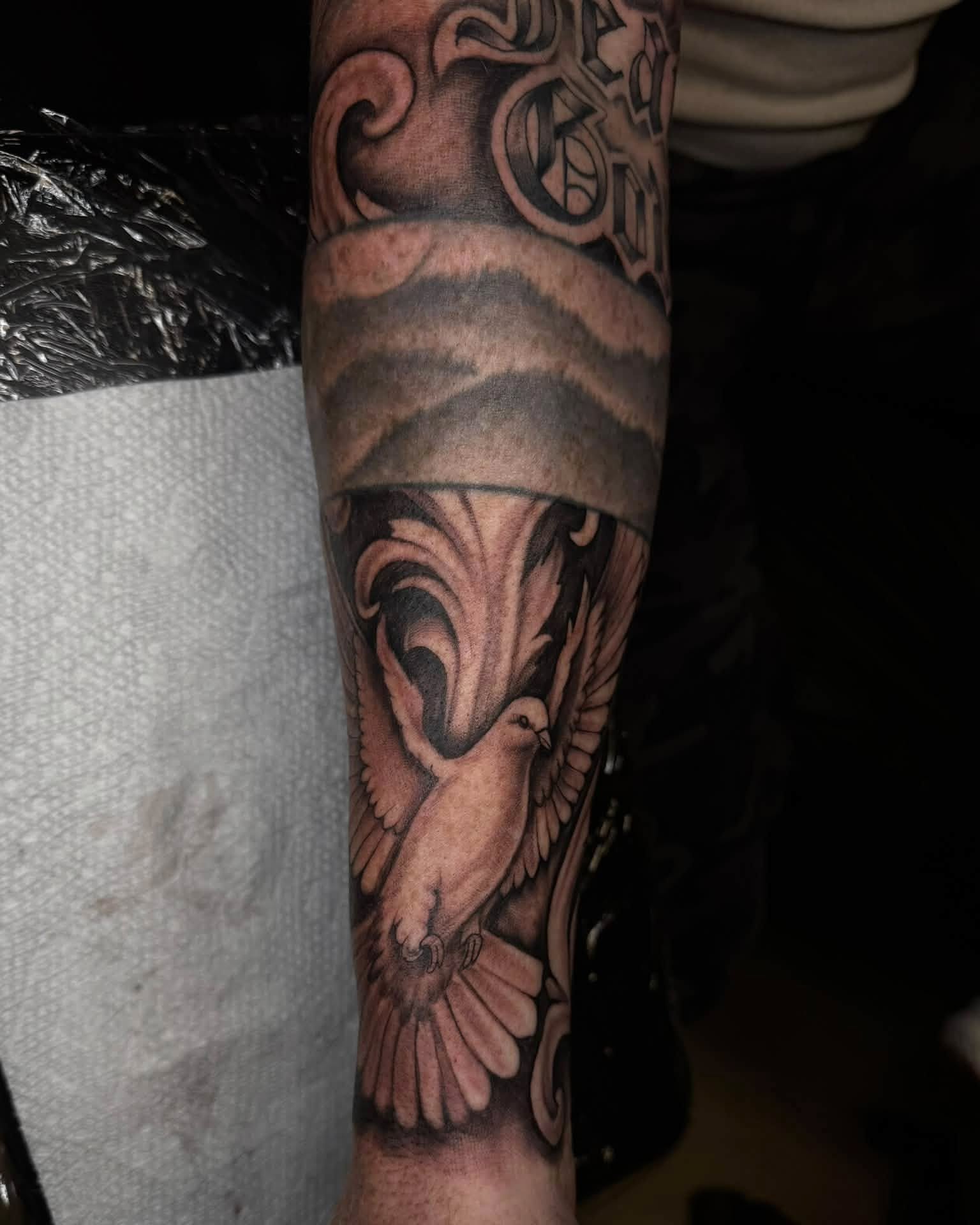 Dove black and grey tattoo on the forearm by Madison Jasso