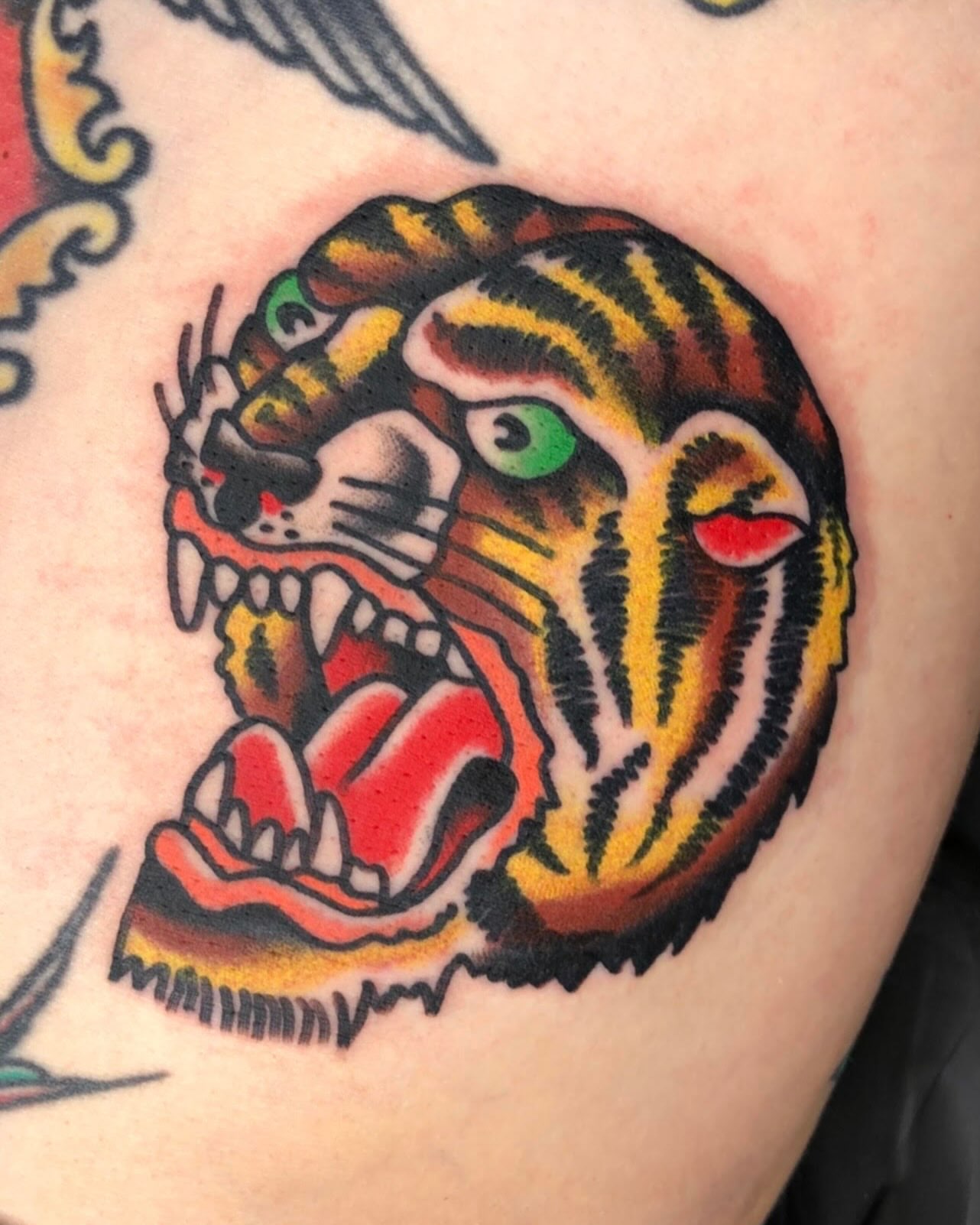 Tiger head American traditional tattoo on the shoulder by Tattoo