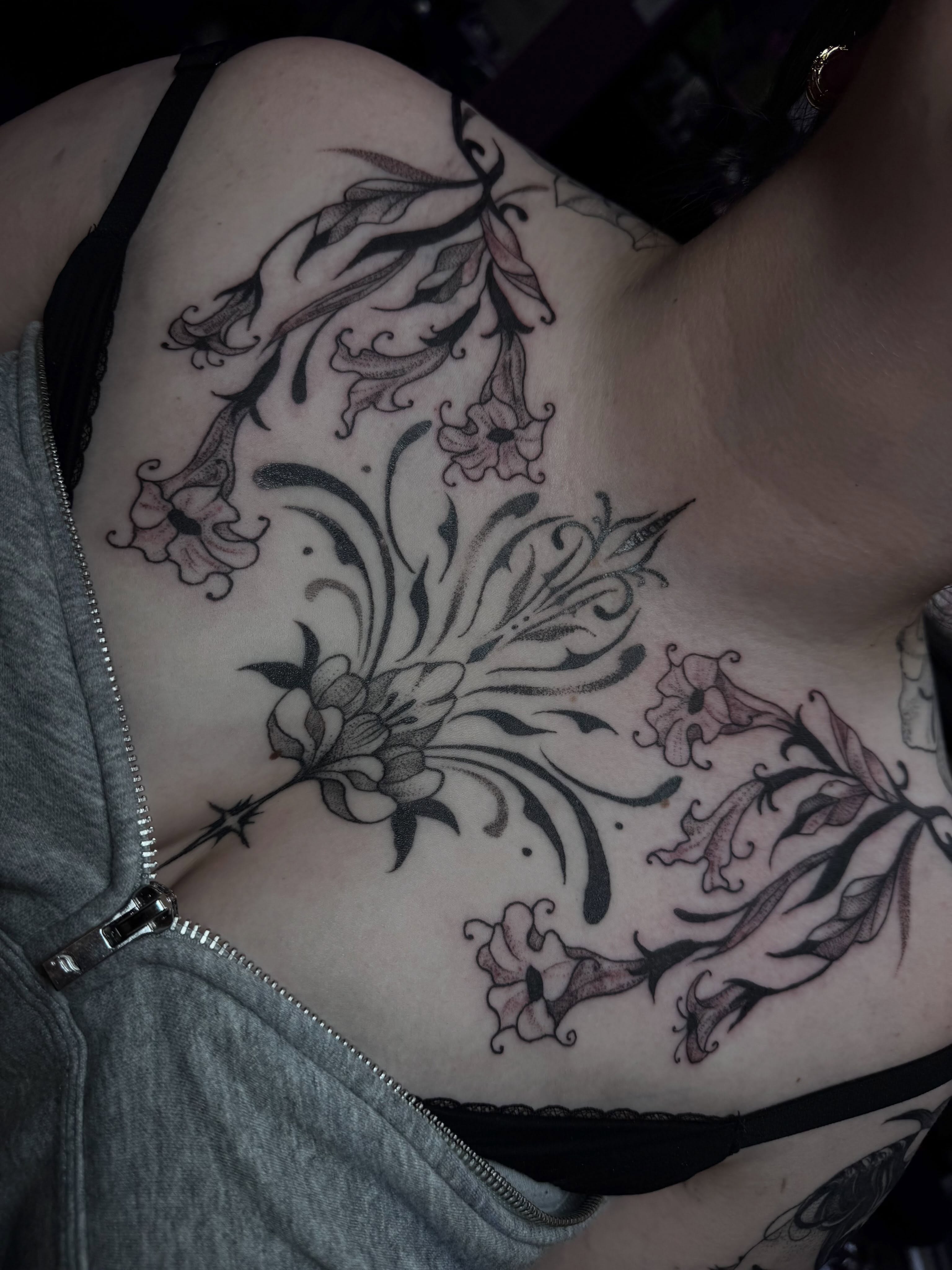 Lilies black and grey tattoo on the ribs by olivia reed