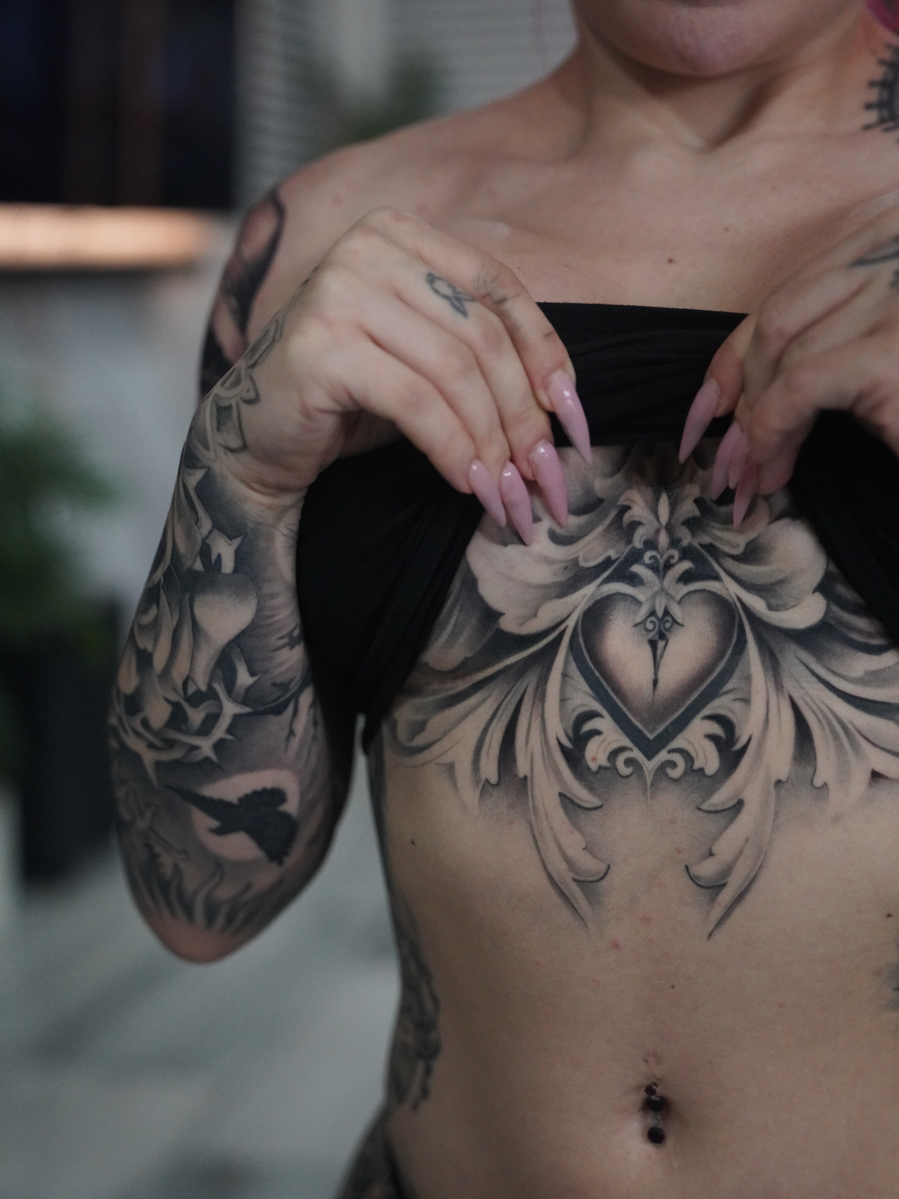 Heart with ornamental design ornamental tattoo on the chest by Artem Kunakuzin