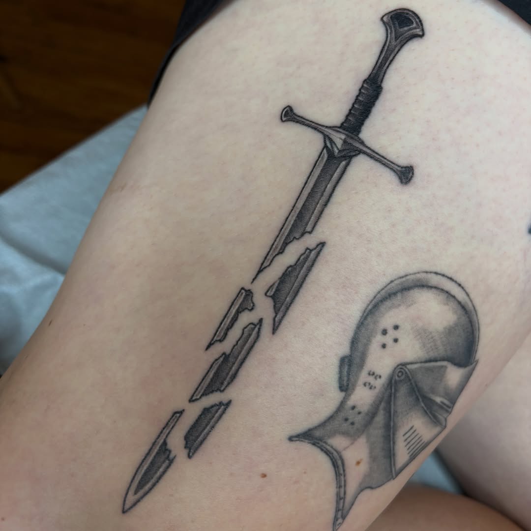 Sword and helmet black and grey tattoo on the forearm by Myla Jane, Houston, Texas