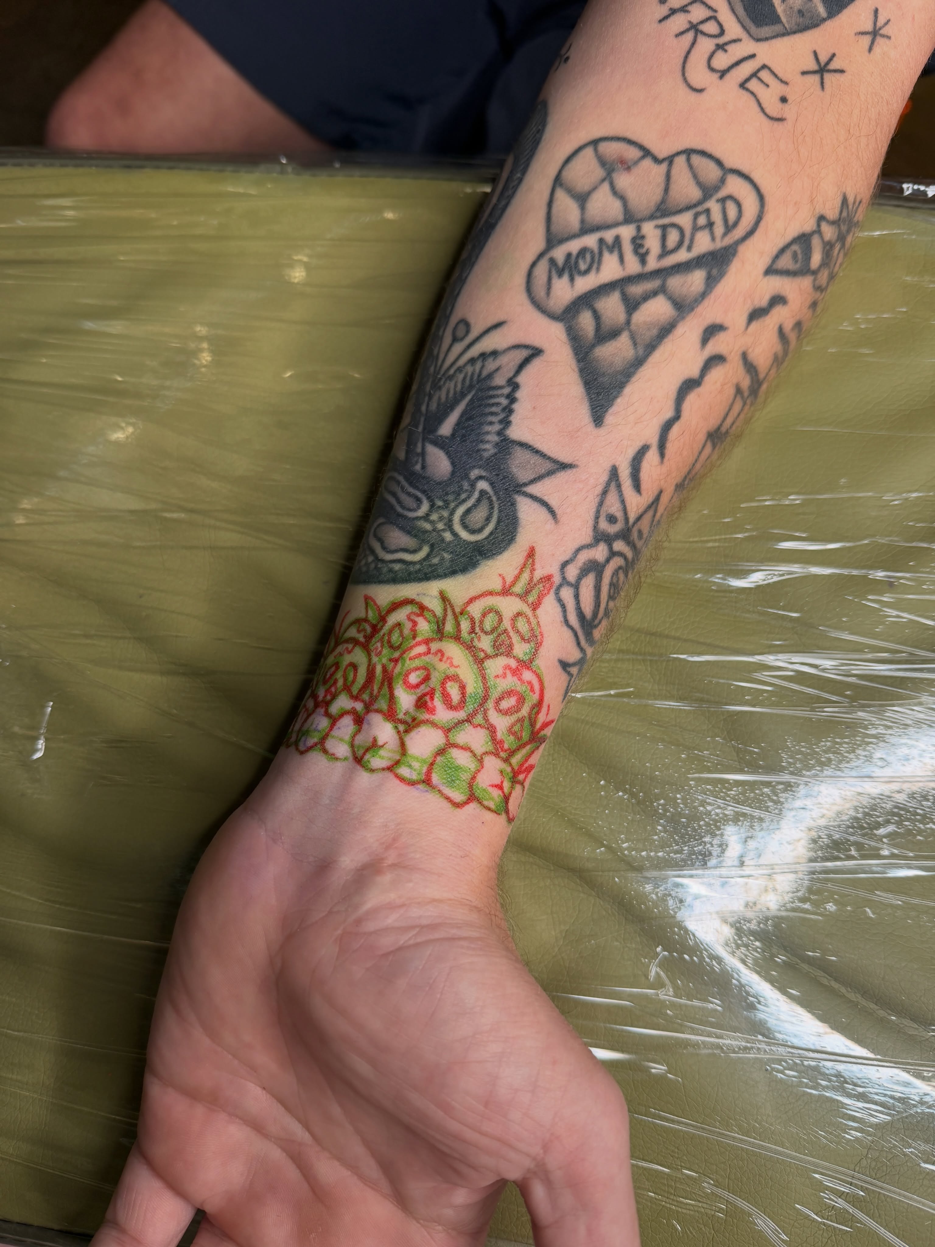 Flower bouquet American traditional tattoo on the forearm by Andrew Storm