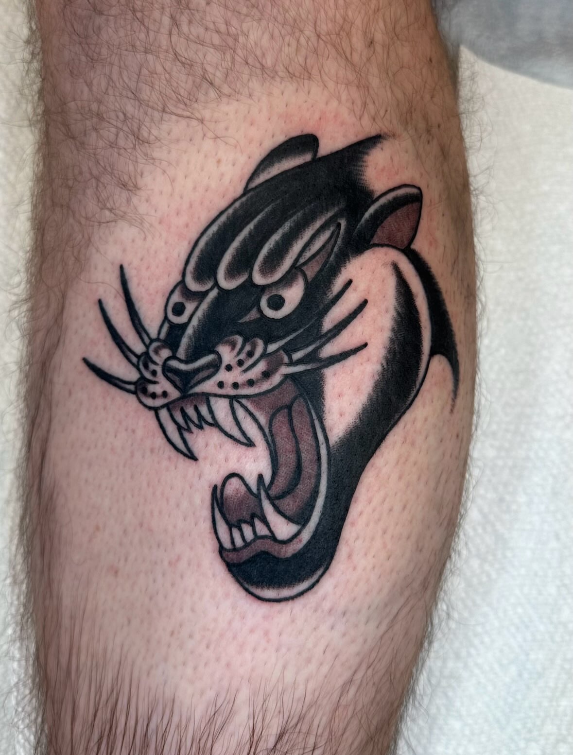 Panther American traditional tattoo on the forearm by Zahra Niedermann