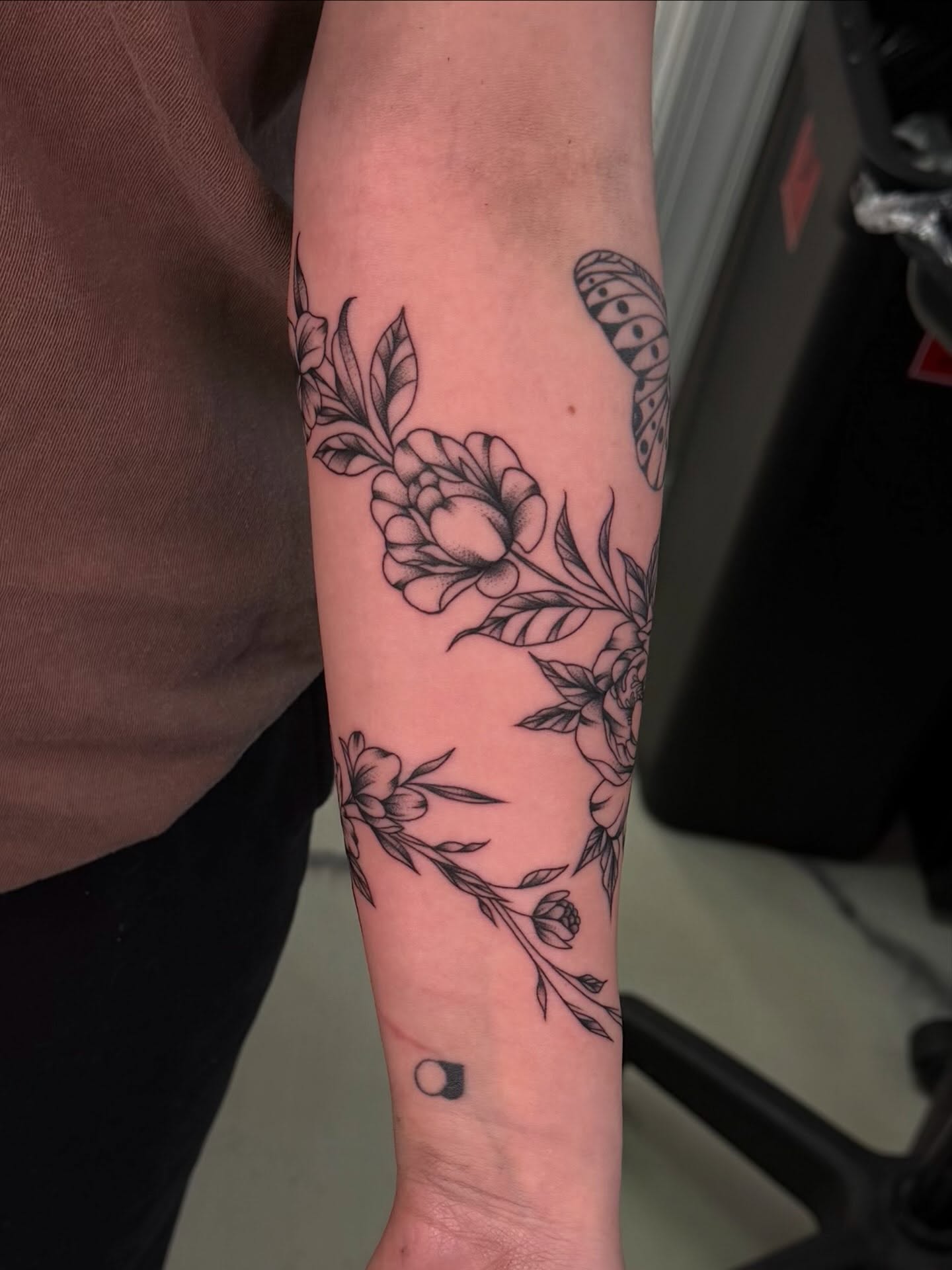 Floral bouquet black and grey tattoo on the forearm by haylie