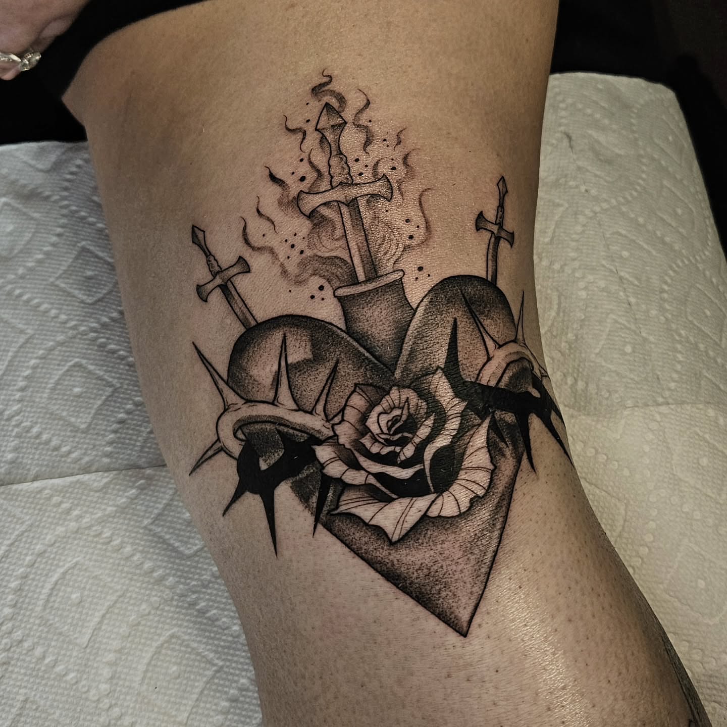 Heart with roses and swords dotwork tattoo on the thigh by Courtlyn Bliss