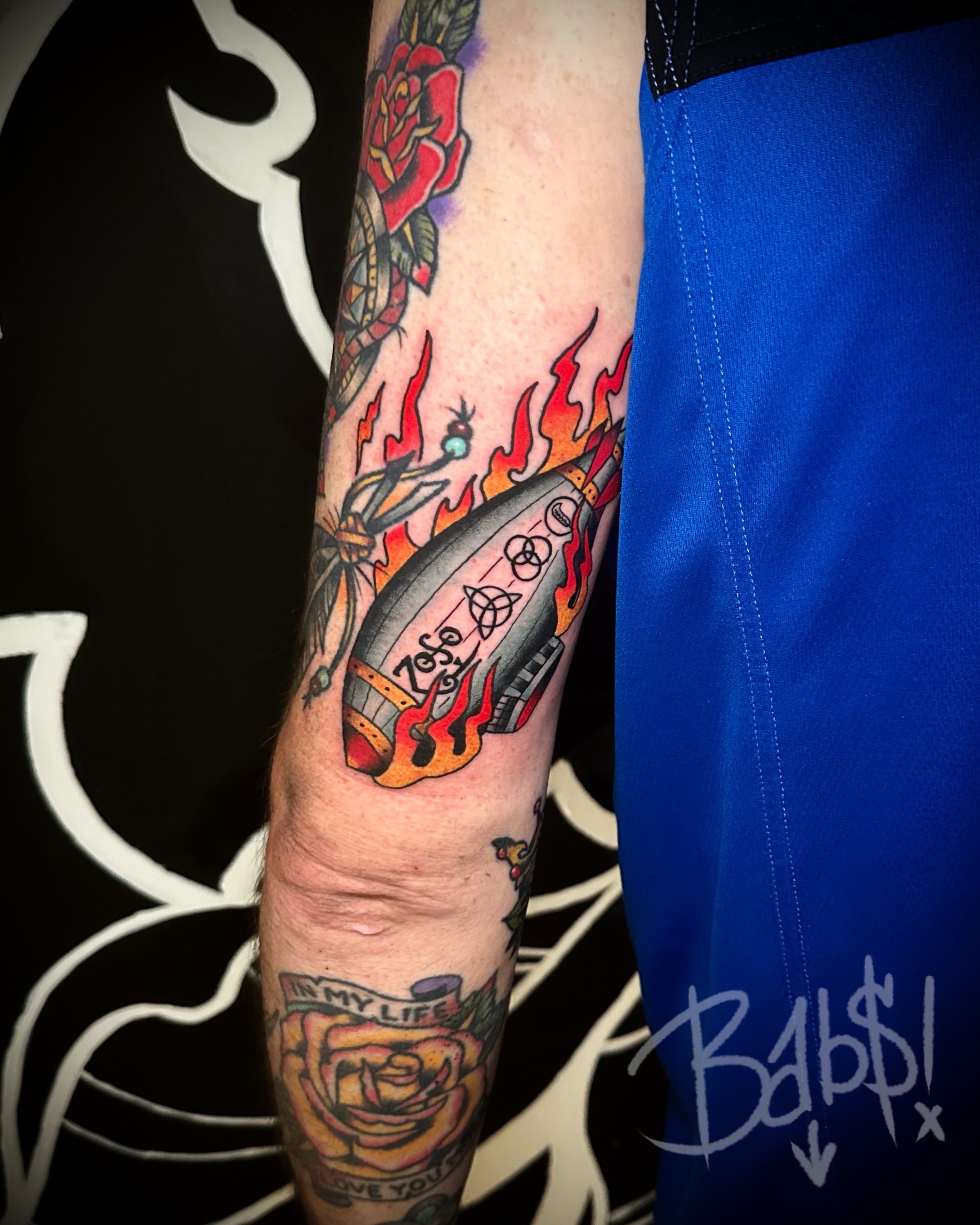 Rocket ship American traditional tattoo on the forearm by Justin B