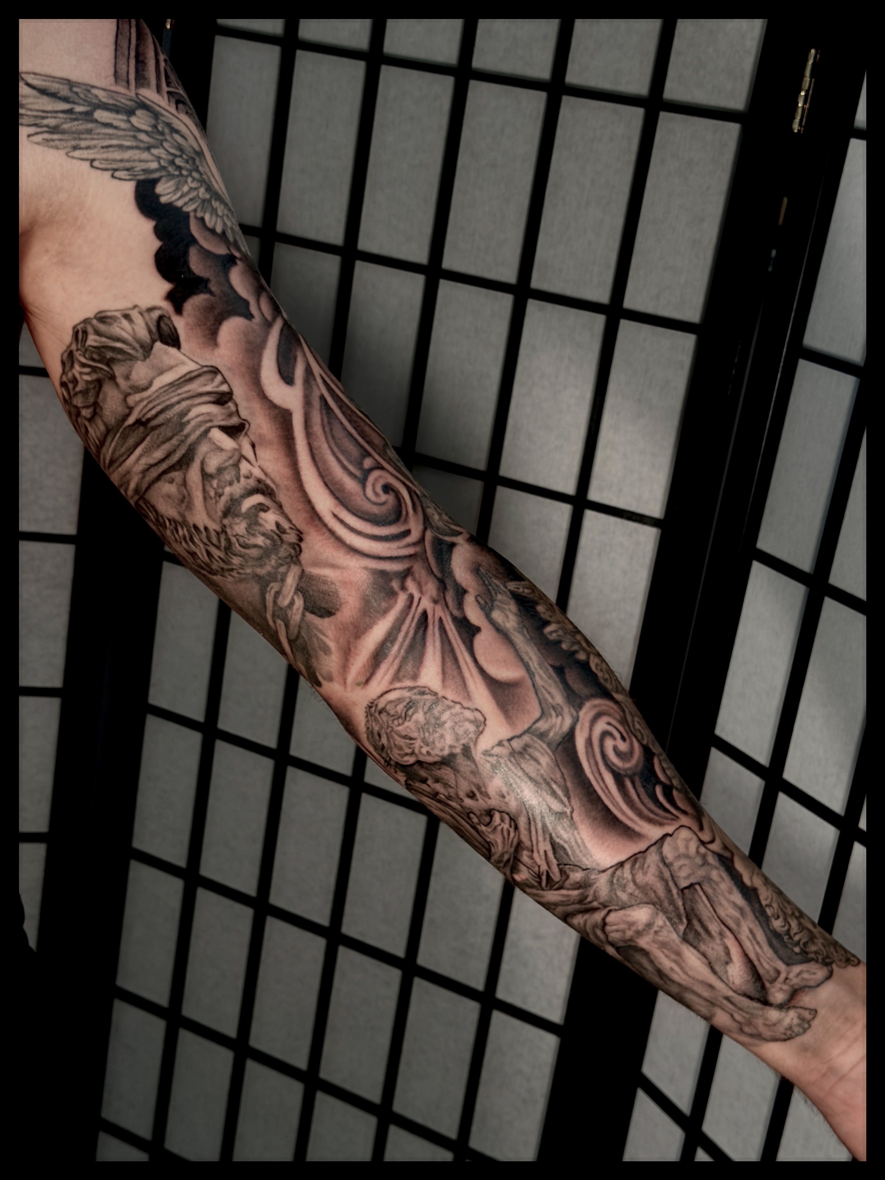 Winged angel realism tattoo on the forearm by Noah Morris
